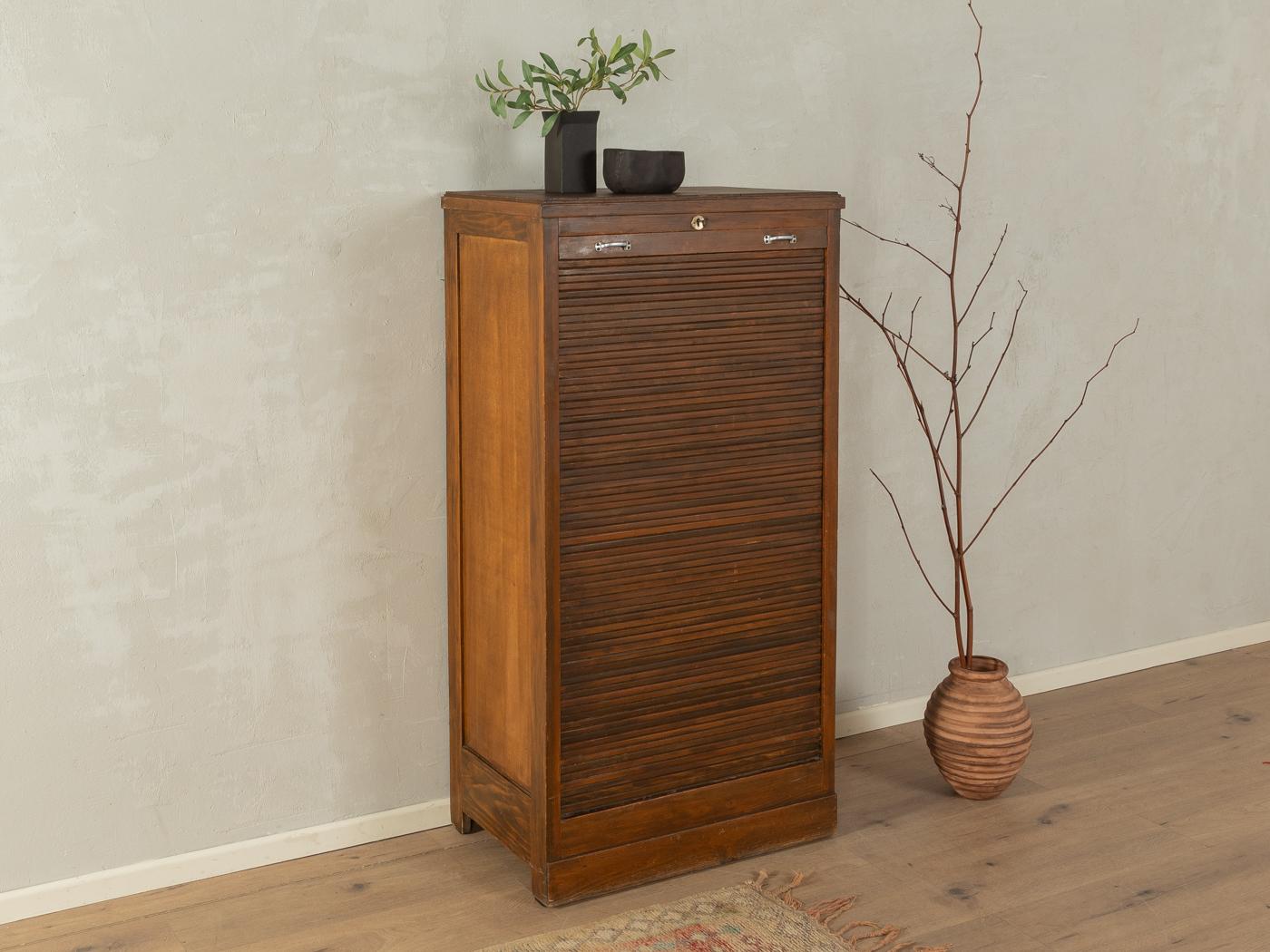 Unique Art déco roller shutter cabinet from the 1920s. Corpus in dark stained oak veneer with two drawers and two shelves.

Quality Features:

    very good workmanship
    high quality materials
    solid wood drawers
    Made in Germany