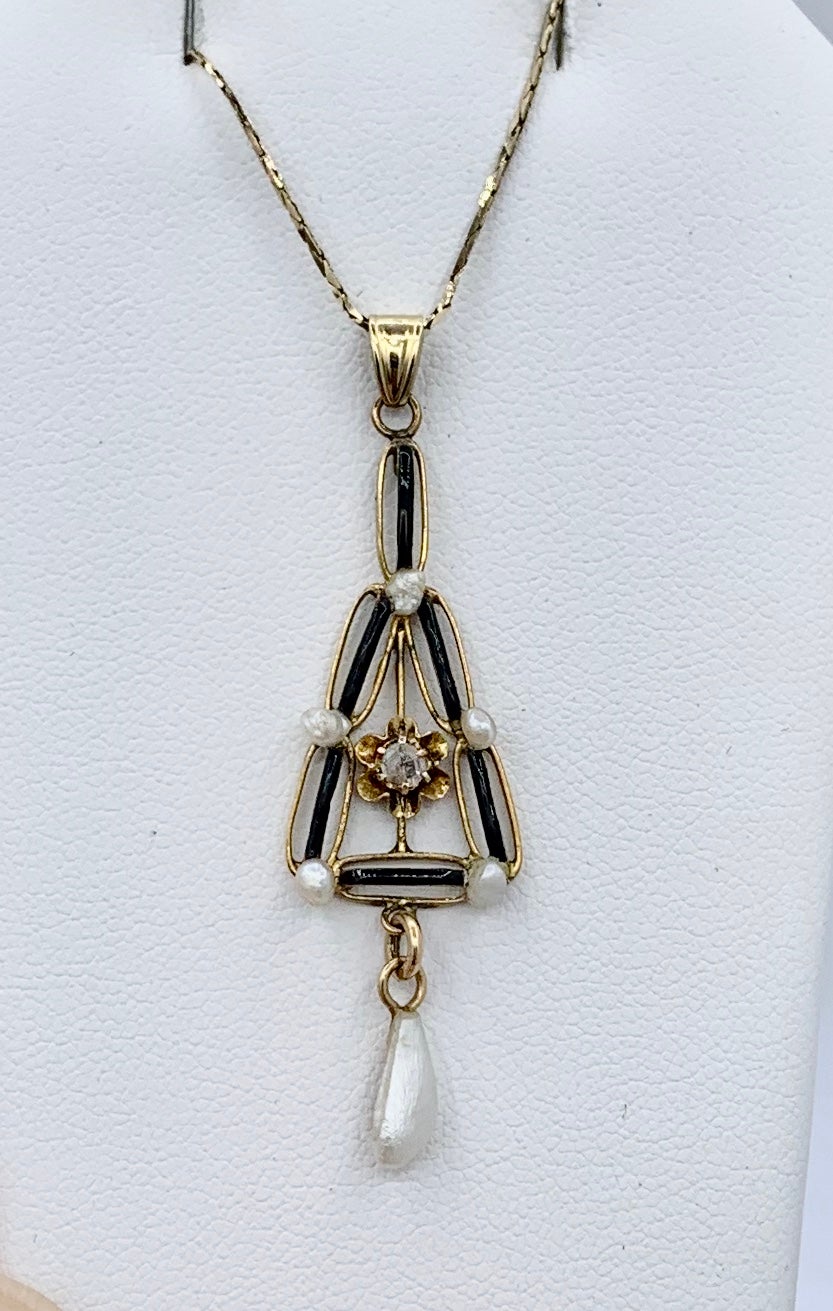 This is a beautiful antique Art Deco early 20th Century Rose Cut Diamond, Black Enamel and Pearl Pendant Lavaliere in 14 Karat Gold.  The exquisite pendant has delicate open work design, wonderful Art Deco styling, and beautiful gems.  In the center