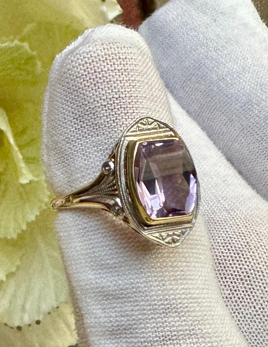 This is an extraordinary antique Art Deco Ring with a stunning rectangular faceted Rose De France Amethyst in the center in a gorgeous setting in Platinum and 14 Karat Yellow Gold.  The amethyst is 10mm by 8mm and is a stunning gem with beautiful