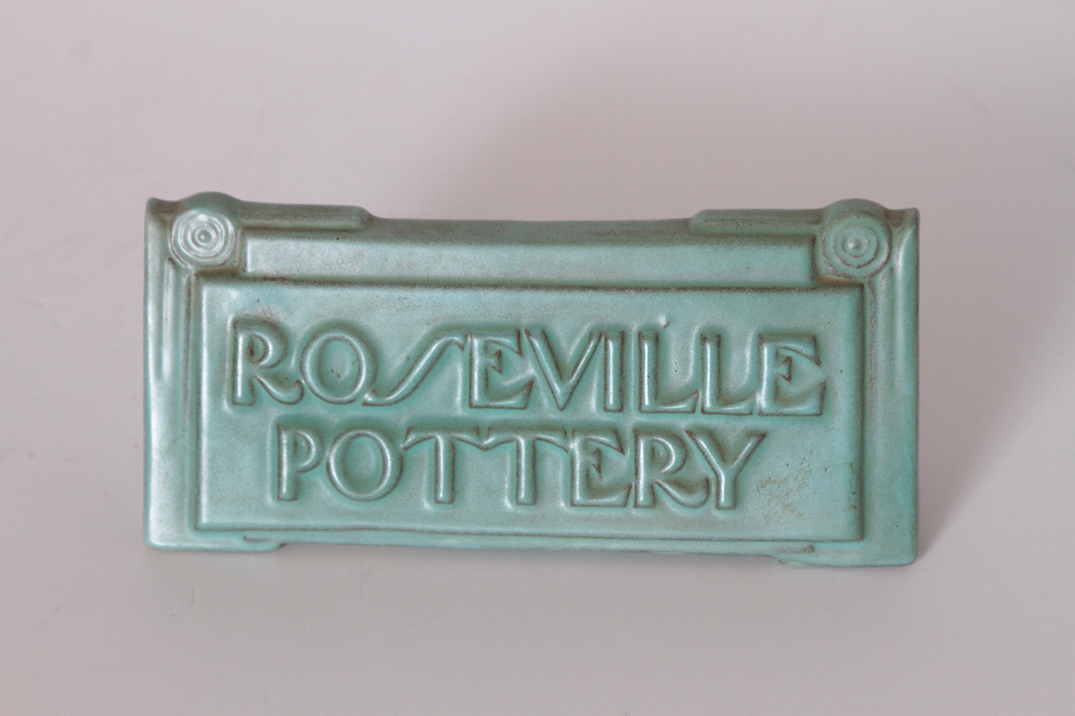 Art Deco Roseville Moderne retailer's advertising ceramic sign 

Rare example of the original modernist dealer advertising complement to the Moderne line by Roseville. Introduced in 1936.

No chips, cracks or hairlines evident. Typical factory