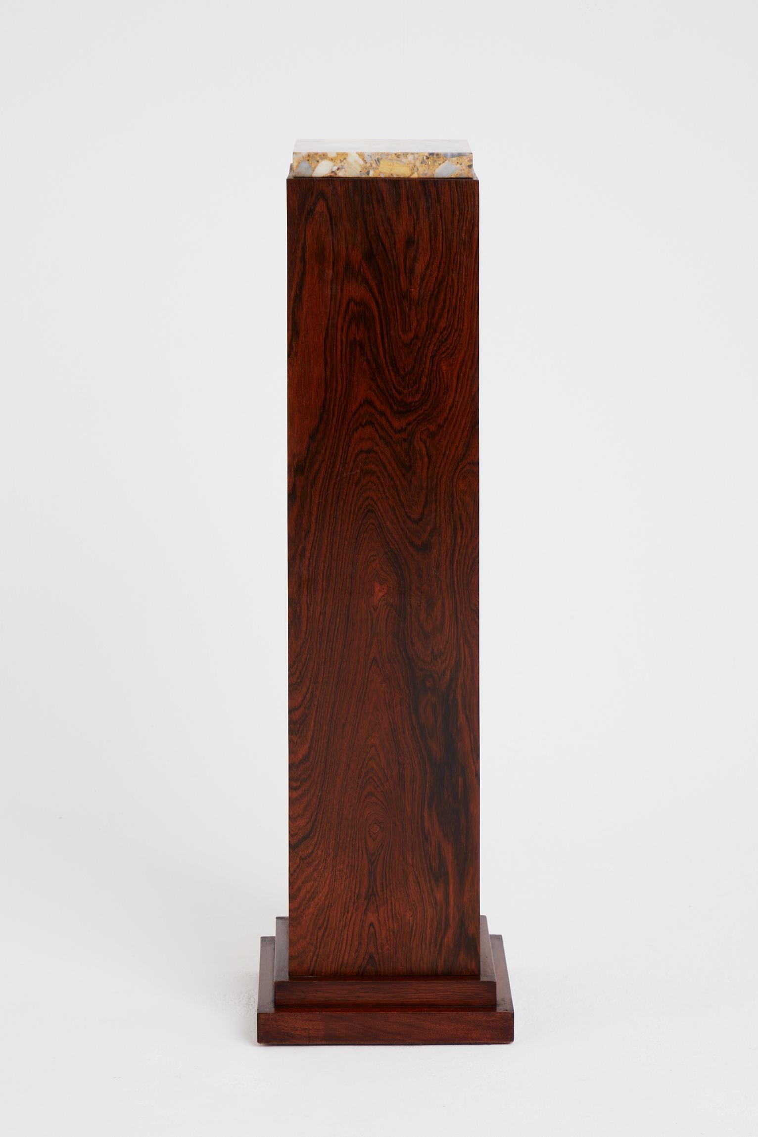 An Art Deco rosewood and marble-top pedestal.
France, circa 1930.