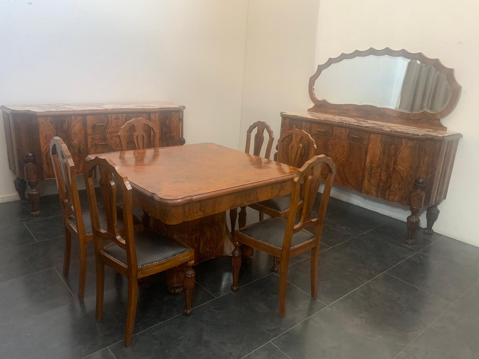 High cabinetry dining room set, consisting of: 2 sideboards, a mirror, table and 6 chairs. 
The sideboards are moved, with finely carved feet in an elongated pine cone with an upper ebonized sphere, inserted in a niche. l tops in Breccia Medicea