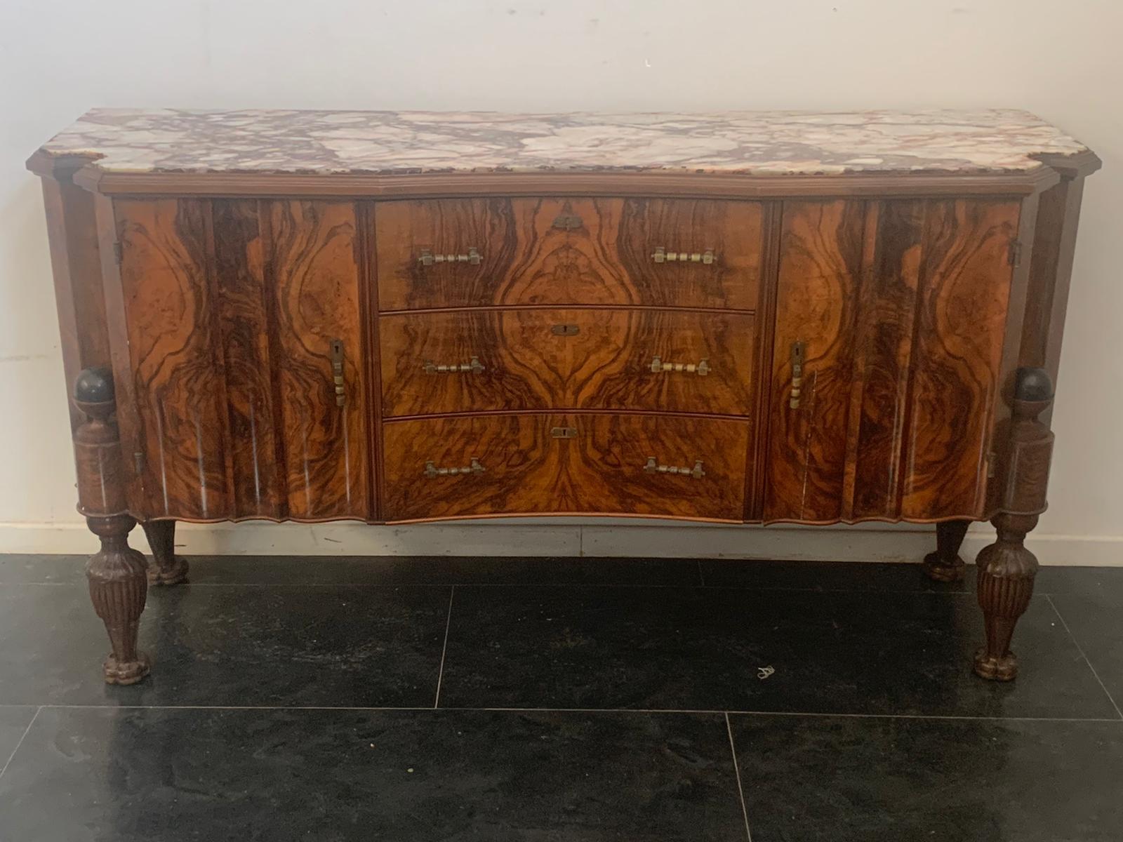 Art Deco sideboards, with 2 doors on the sides and 3 drawers in the center. The feet finely carved in elongated pine cone with ebonized sphere above, are inserted in a niche groove. The marble top is in breccia medicea, an exclusive stone with