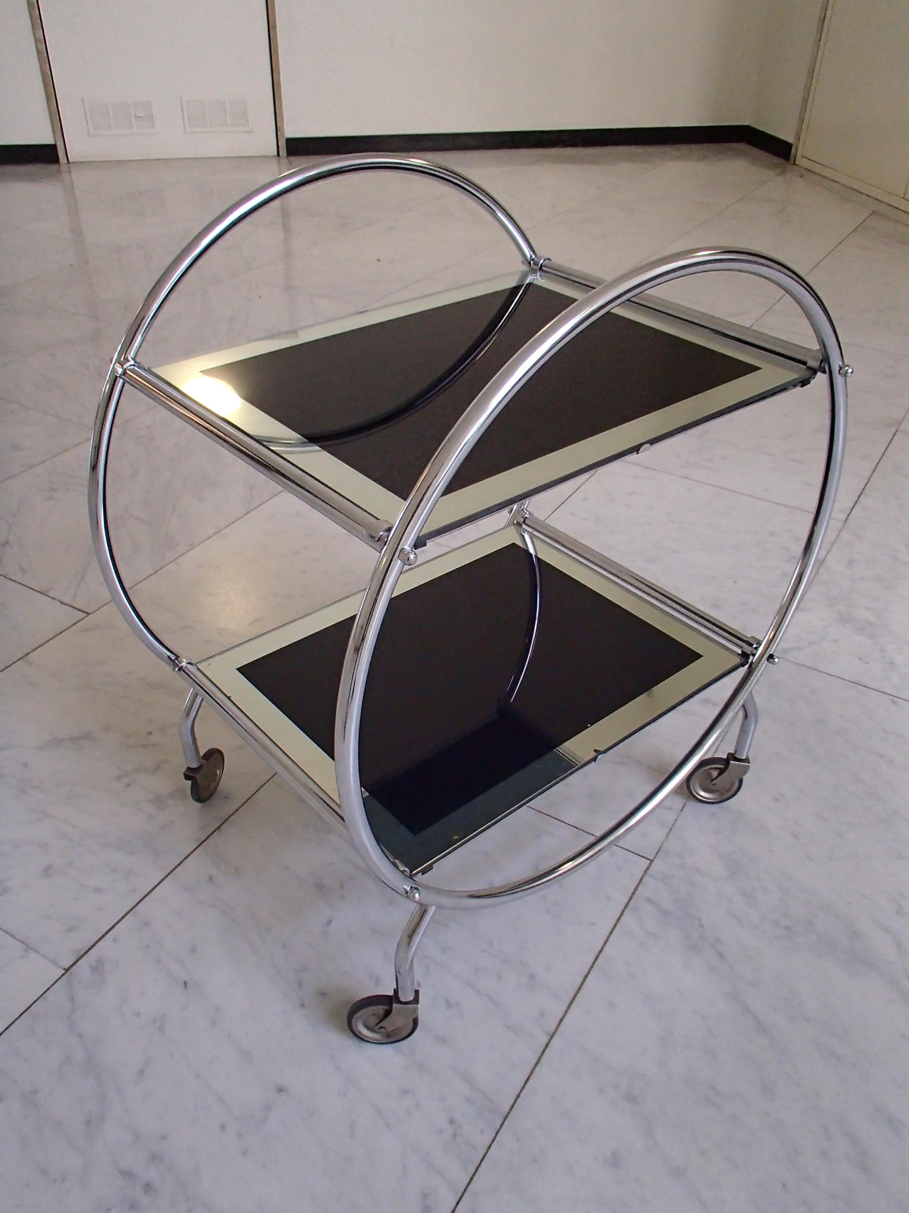 Art Deco round chrome trolley with black and silver glass.