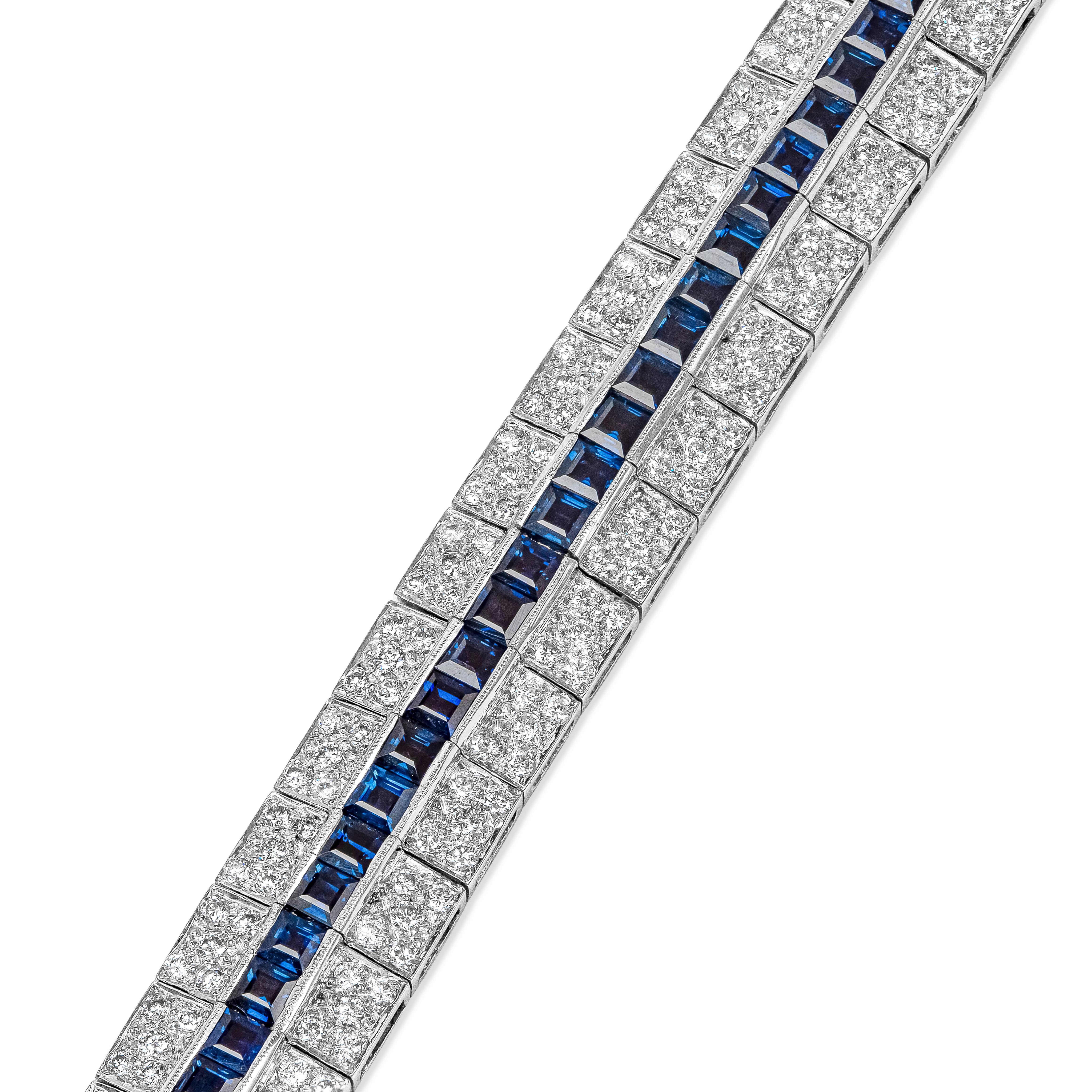 An beautiful art deco bracelet showcasing a line of square cut blue sapphires weighing 9.20 carats total. In-between the sapphires are round diamonds weighing 4.02 carats total, G color and SI in clarity. Finely made in 18k white gold and 7 inches