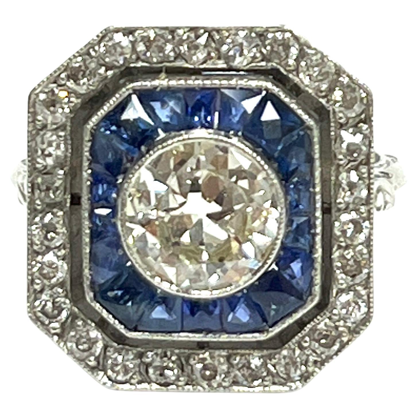 Art-Déco-Ring mit rundem Diamant und Calibre-Saphir
