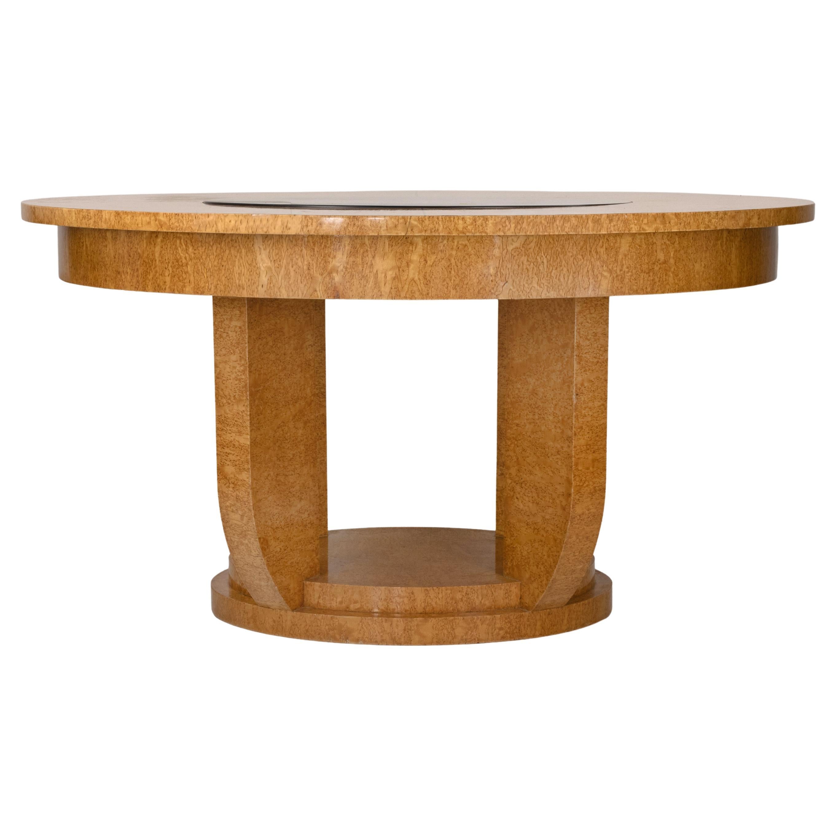Vintage round dining table realized in Art Déco style by a french manufacturer in 1930s.

Bird’s-eye maple veneer, ebonized glass inset, and lacquered finish.

A refined and architectural Art Deco round table exemplifying the harmony between