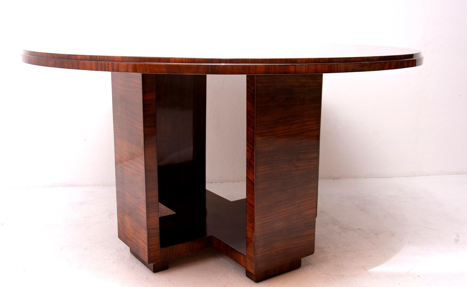 This Art Deco/Functionalist dining table was made in the 1930s in Bohemia, designed by the famous Prague architect Vlastimil Brožek. The bottom part features a regular shaped legs typical for Functionalism in the 1930s. The table was created by an