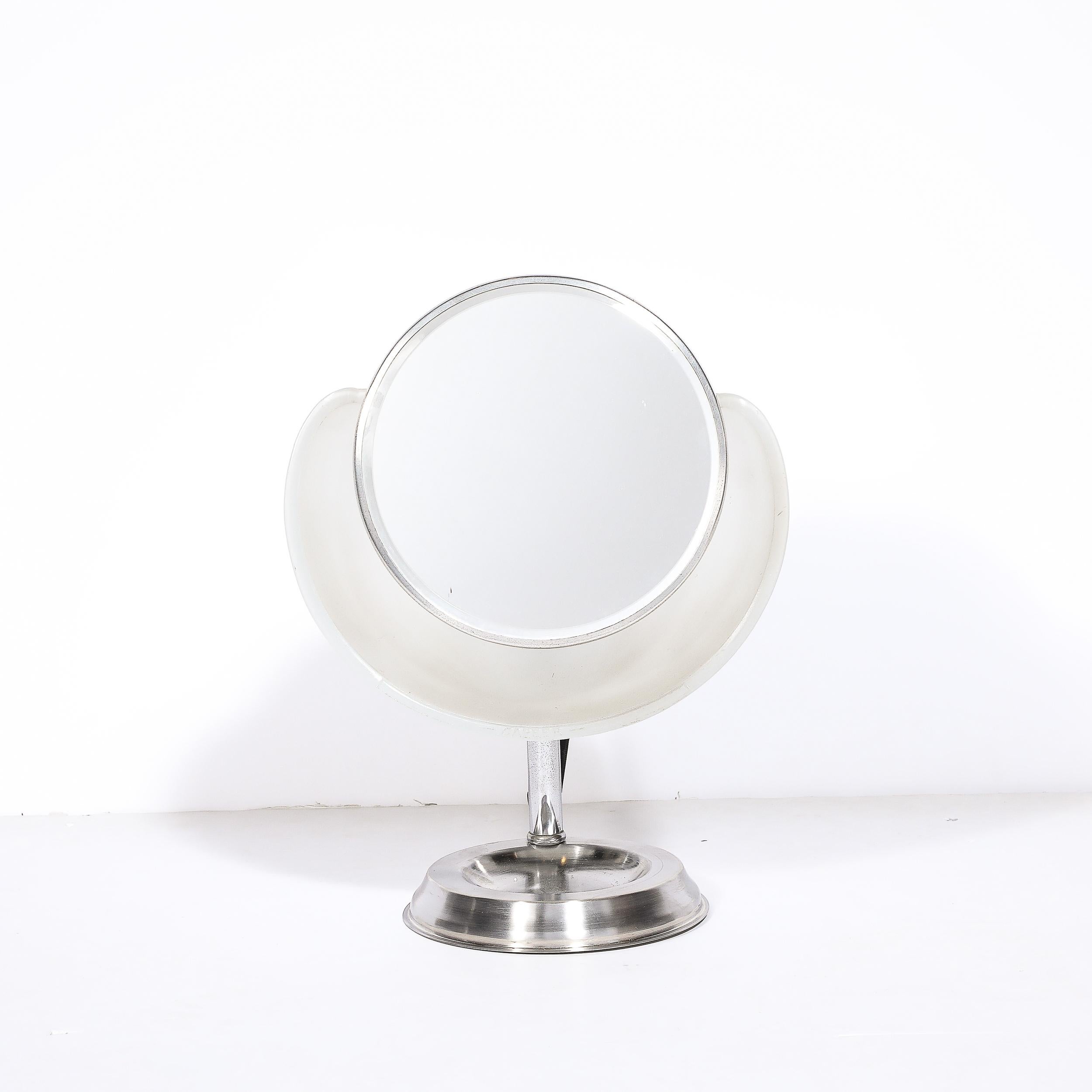 This unique and materially exquisite Art Deco Round Frosted Glass and Chrome Vanity Mirror by Lampeer Lamp Co. was created in the United States in 1928. Features a round central pane of mirror circumscribed with chrome, beautifully polished and