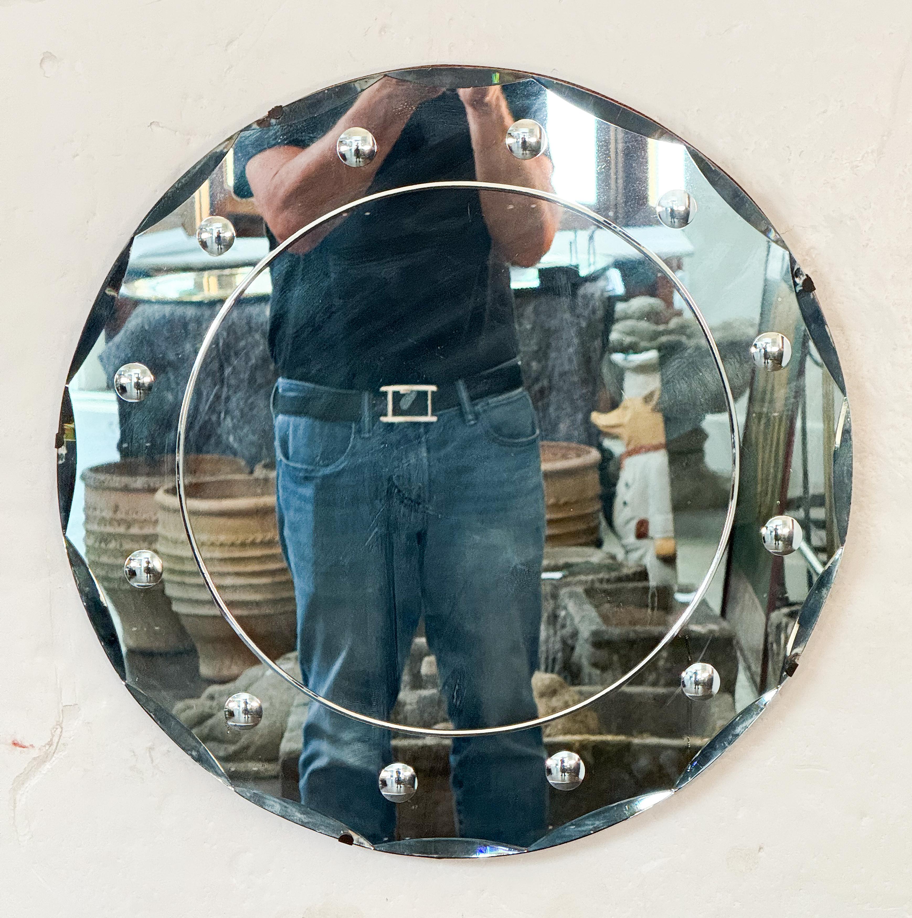 A fine English round or circular mirror from the Art Deco era, featuring a scalloped beveled edge with decorative beveled roundels around the circumference on a wood backing.