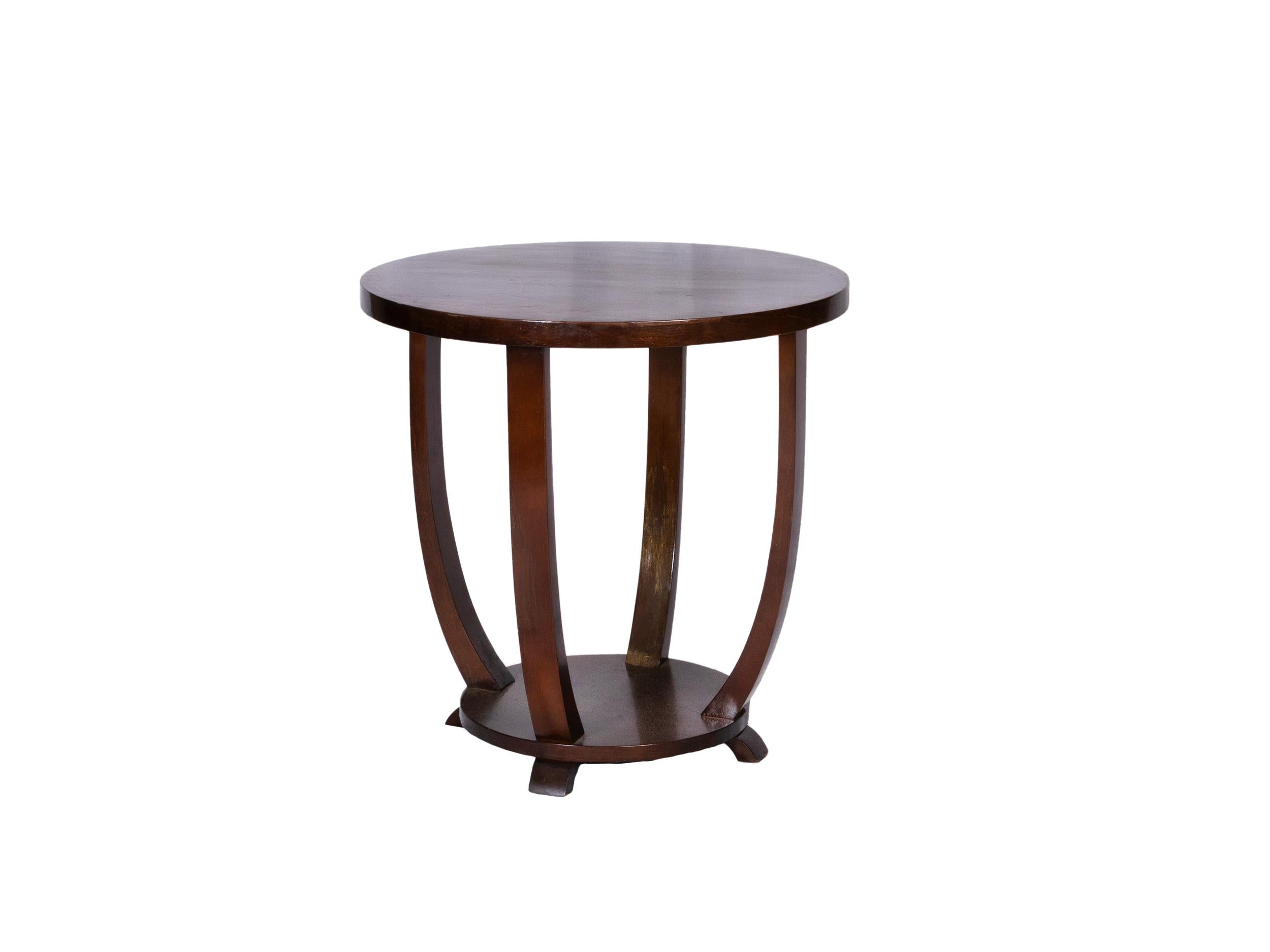 This Art Deco walnut side table from 1920s France was crafted with a round two-level structure, it features four gracefully curved legs connected to a circular base.

A true statement piece, this table captures the bold geometry and refined