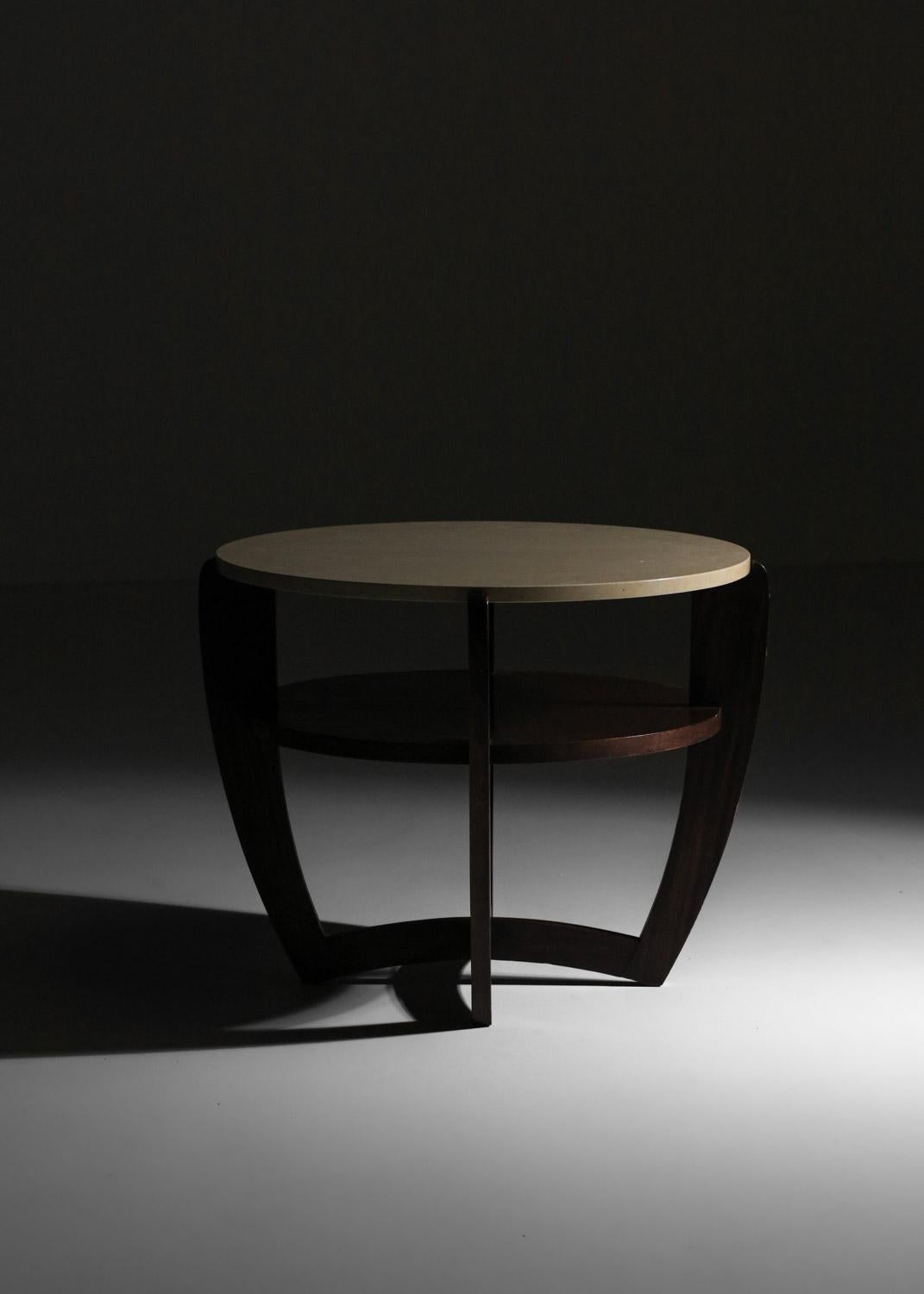 Round French coffee table in the taste of Sornay's work from the 50s. Solid wood pedestal table structure and round travertine top. Sober, elegant design, very fine vintage condition with slight traces of age and use (see photos). 