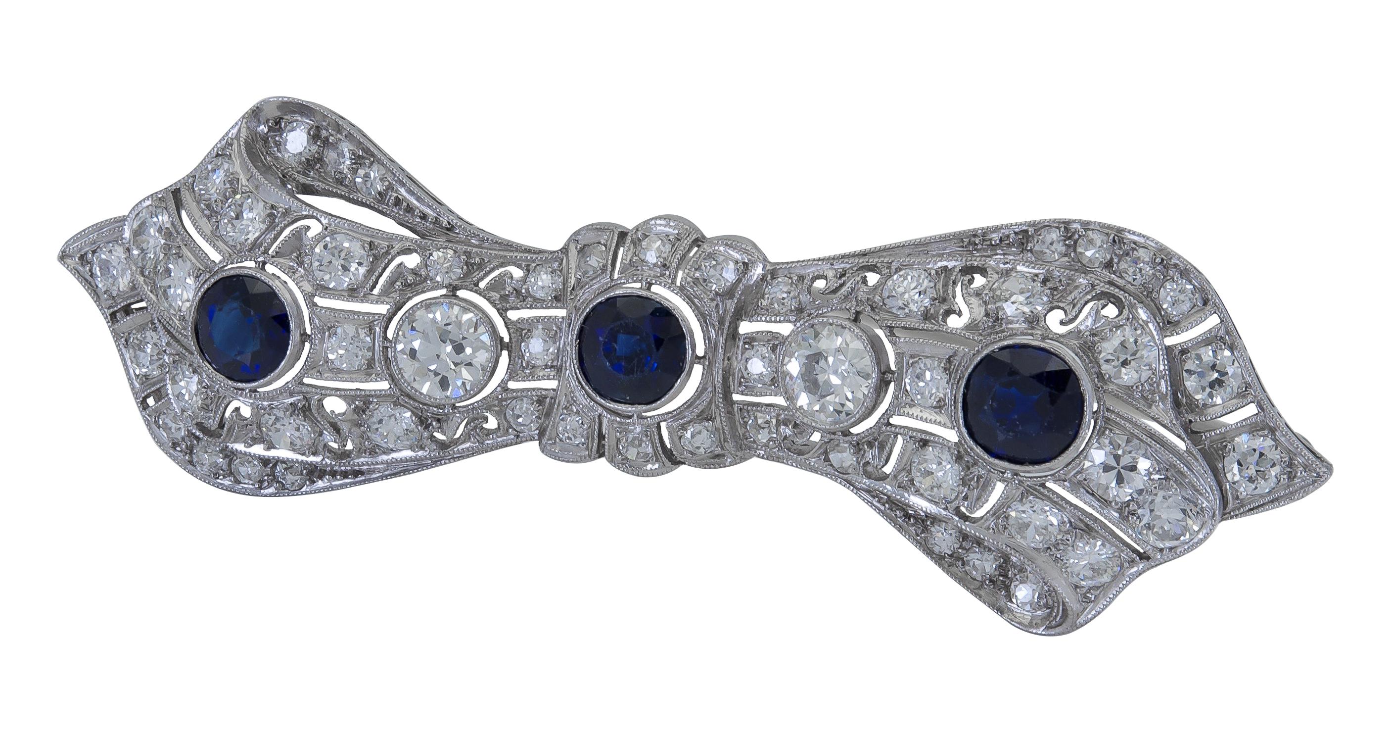 A beautiful and antique brooch showcasing a combination of blue sapphires and brilliant round diamonds set in an art deco panel design.
Dimensions: 2.00 cm (L) x 6.70cm (W)
