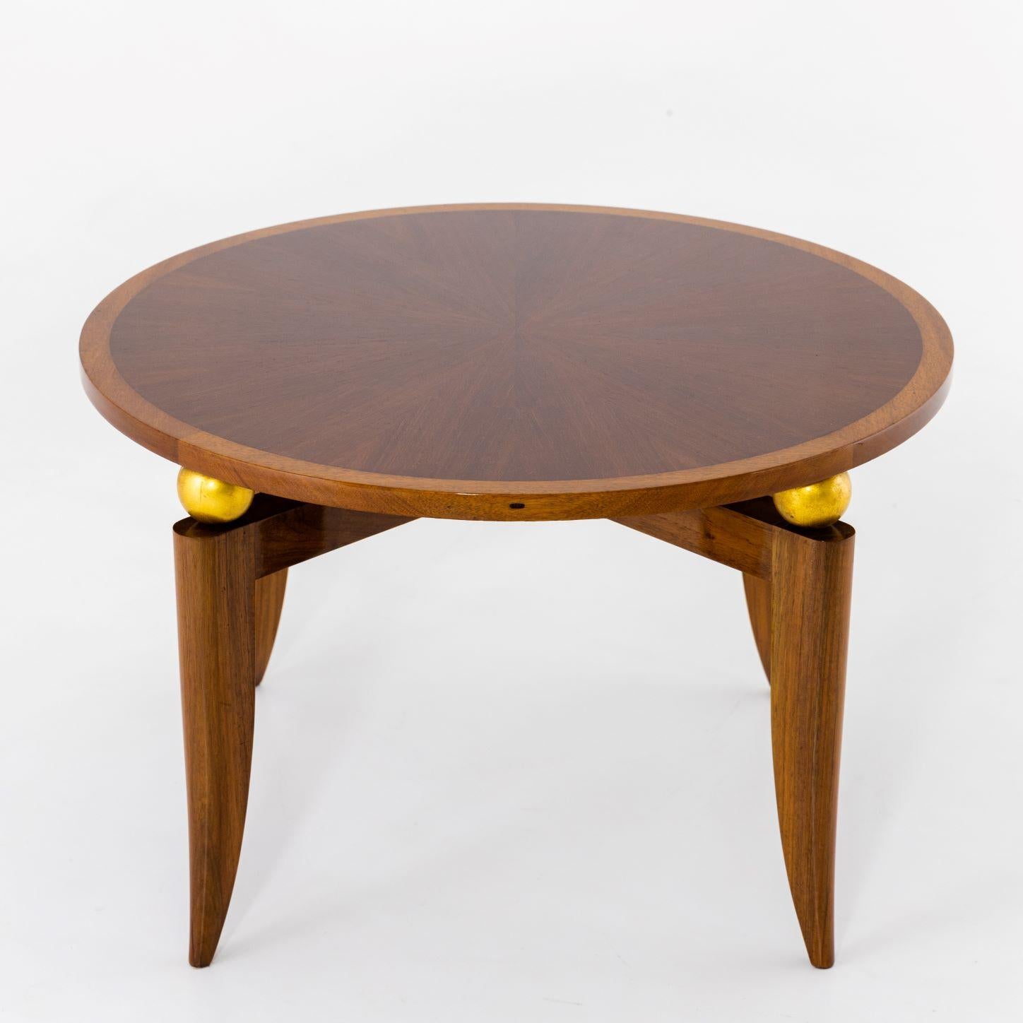 An Art Deco round side table.
Mahogany with gilded details.