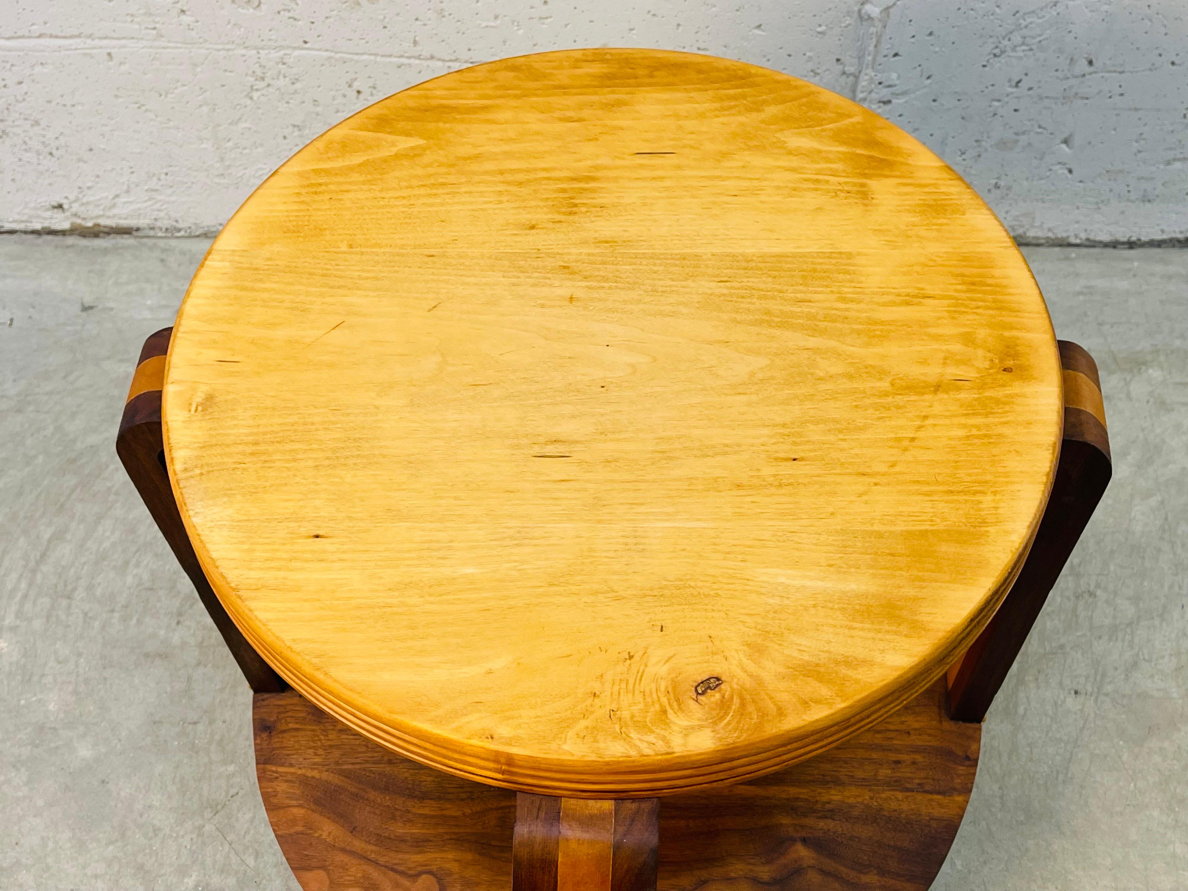 Art Deco round solid wood side table made from maple and walnut woods. The legs have the combination of woods. The table has all rounded edges. The table is solid and sturdy. No marks. 