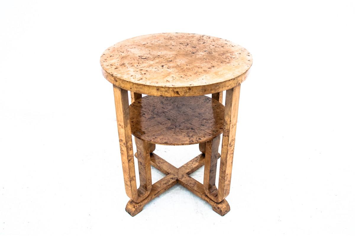 A unique table in the Art Deco style. Produced in Poland at the turn of the 1940s and 1950s. Made of bent wood, veneered with birch brush. The unique bent round shape and the double top give the furniture a stylish Art Deco style. Very good