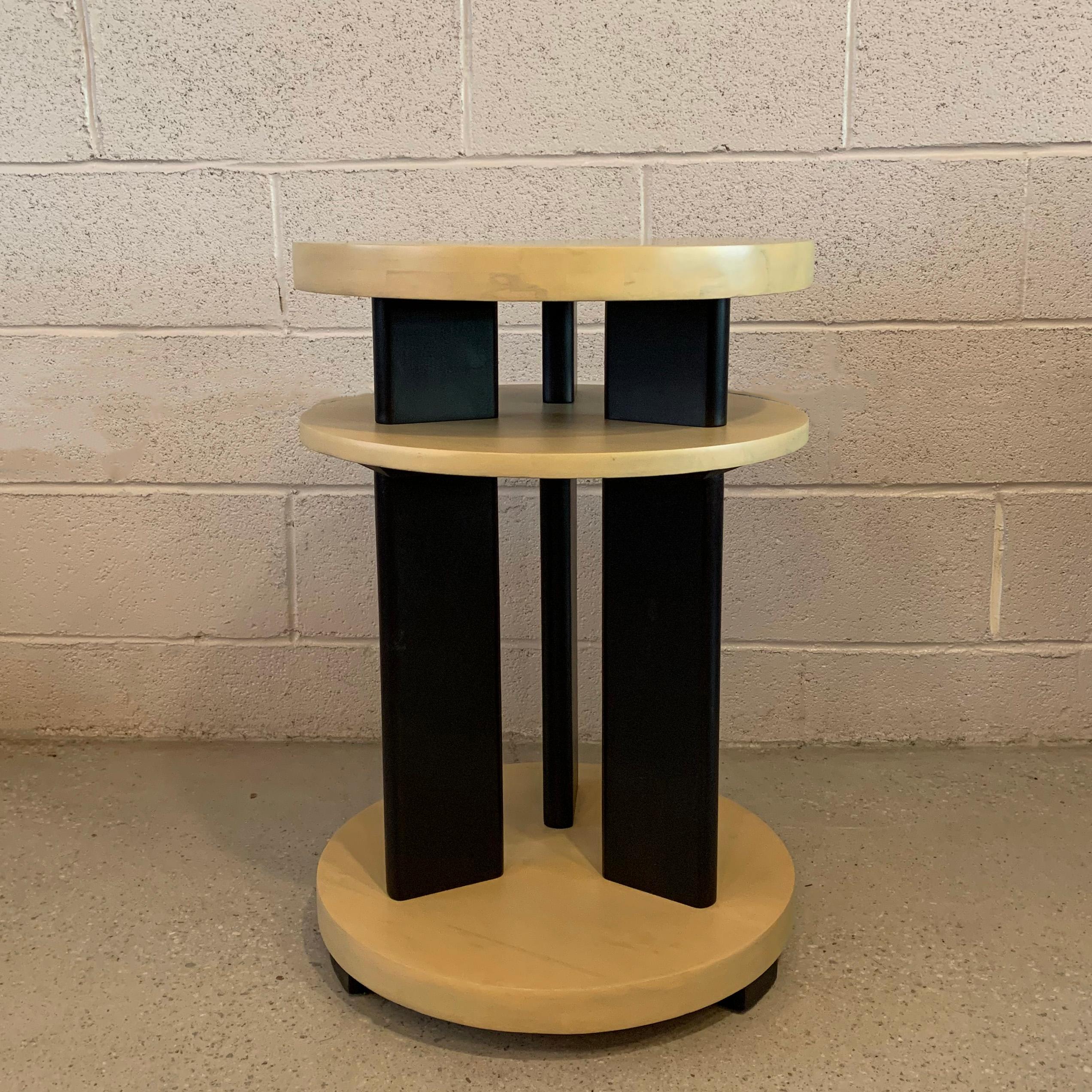 Striking, Art Deco, tiered side table attributed to Gilbert Rohde features a black lacquered base with three, round, bleached mahogany tiers.