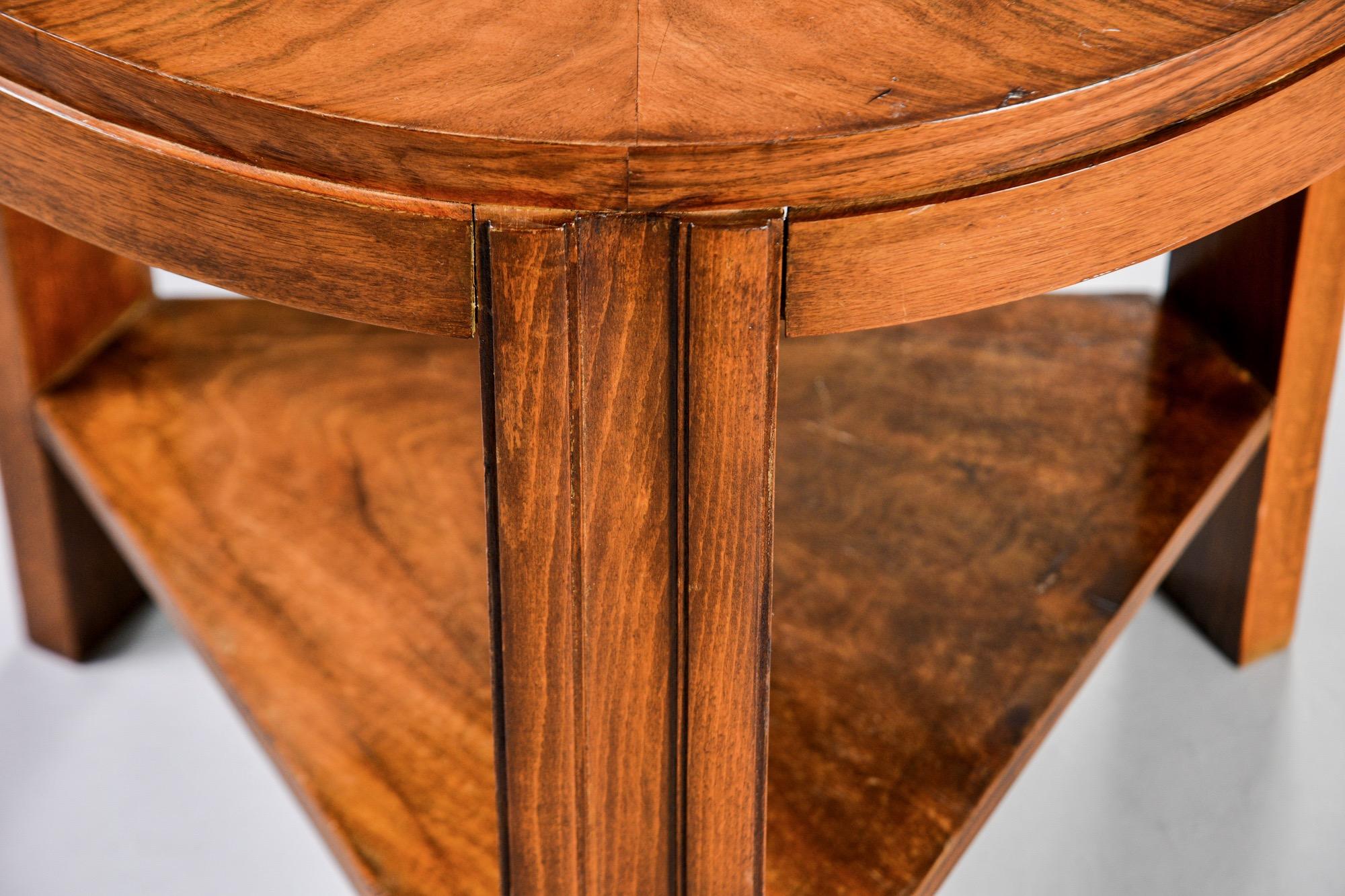 Found in France, this circa 1930s round deco table has figured walnut veneer top and triangular shaped lower shelf. Unknown maker.
    