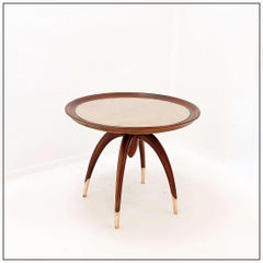 Art Deco round wooden side table with curved legs and brass feet
