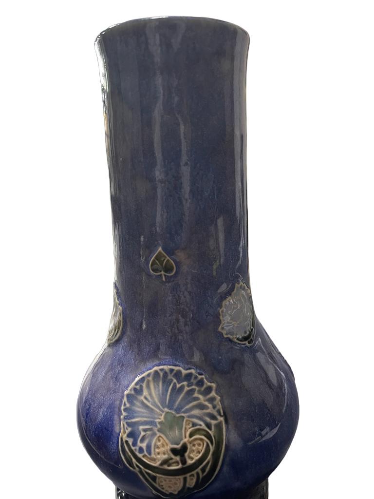 Vintage Royal Doulton Stoneware Signed Vase featuring a flower decoration. Imprinted on base “Royal Doulton, England, a, 8064A,” with ELF signature.
Decorated with embossed floral and club motifs.
Stamped on underside
In cobalt blue, very good