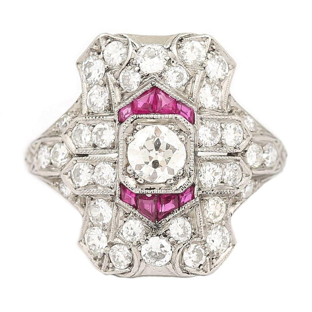 A fantastic platinum Art Deco ruby and diamond plaque ring with an estimated 1.50 carat of Old Mine cut diamonds. The centre stone is 0.35 carats and all stones are millegrain set in this stylish antique ring. Completing the geometric shape, the