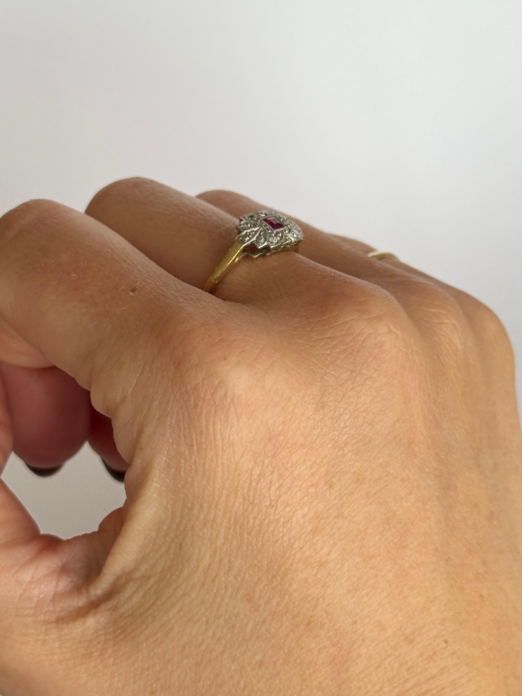 This gorgeous ring holds gorgeous sparkling diamonds and a ruby.  The stones are set in platinum and the rest of the ring is modelled in 18carat gold. Ruby measures 15pts, diamond total 10pts. 

Ring Size: N or 6 3/4 
Panel Dimensions: 8x13mm