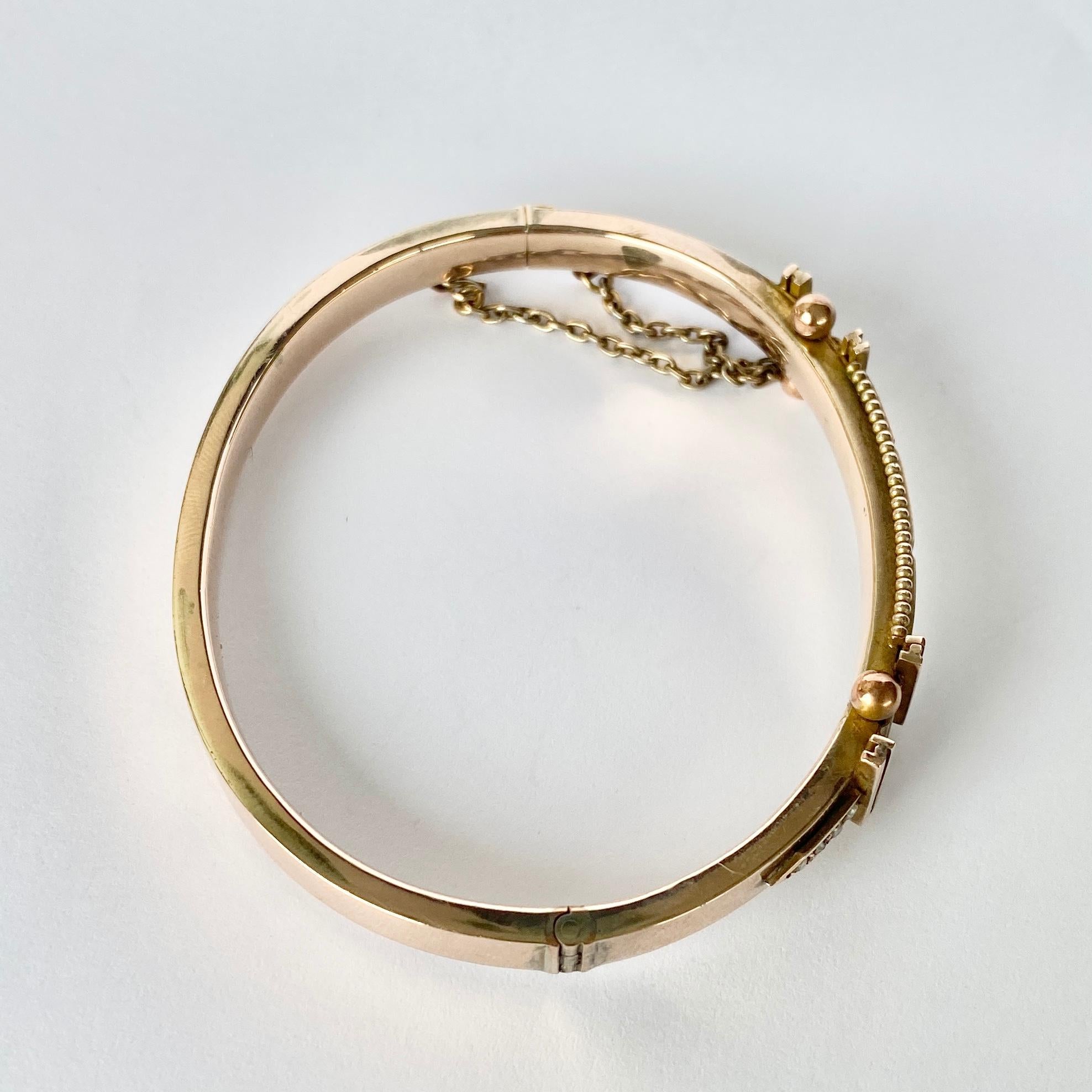 The detailed bangle holds one diamonds and two rubes set in square settings. The diamond measures 10pts and the ruby total is 15pts. The detail on this bangle is stunning and so intricate. Modelled in 9ct gold.

Inner Diameter: 59mm
Bangle Width: