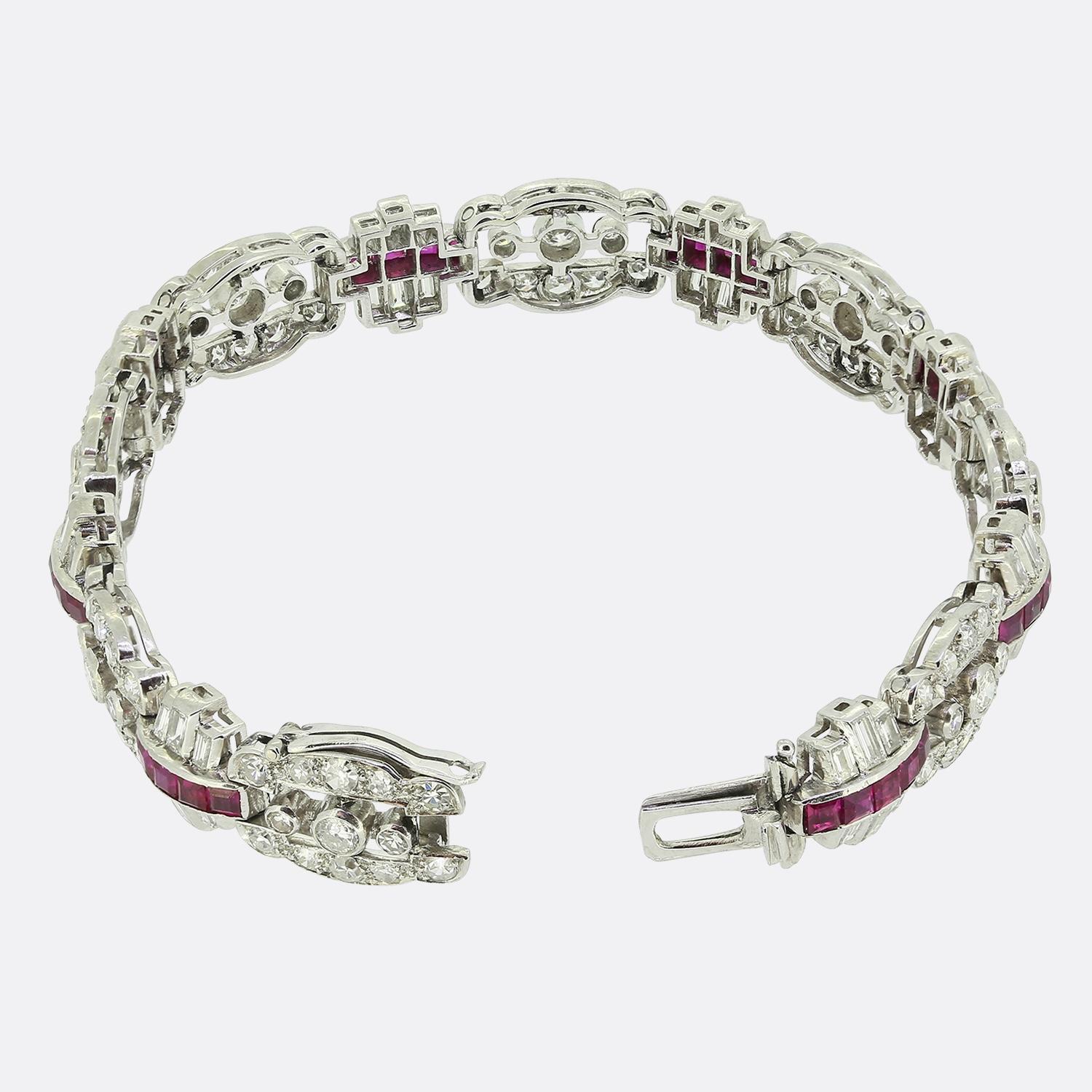 This exquisite bracelet is a true testament to the elegance of Art Deco design. Crafted in platinum, it features a striking combination of pinky red square-cut rubies alongside round faceted old mine and straight baguette cut diamonds. The rubies