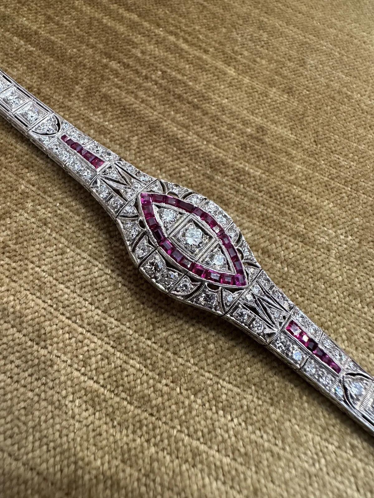 Art Deco Ruby and Diamond Bracelet in Platinum 

Art Deco Ruby and Diamond Bracelet features Old European and Mine Cut Diamonds accented by Rubies set in Platinum with Milgrain edges. Bracelet is secured by a tongue clasp with bar safety.

Bracelet