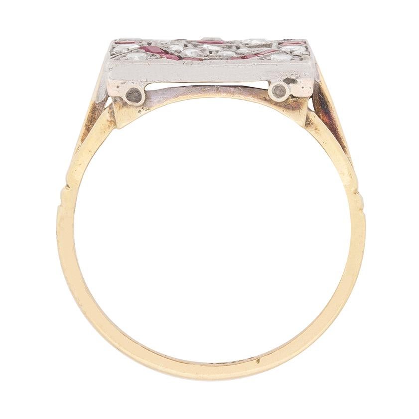 This sensational Art Deco cocktail ring is hand set in a remarkable mosaic-like pattern of 0.30ct rubies and eight cut diamonds, its rectangular platinum mounting displaying all of the geometric elements and millegrain flourishes you’d hope to see
