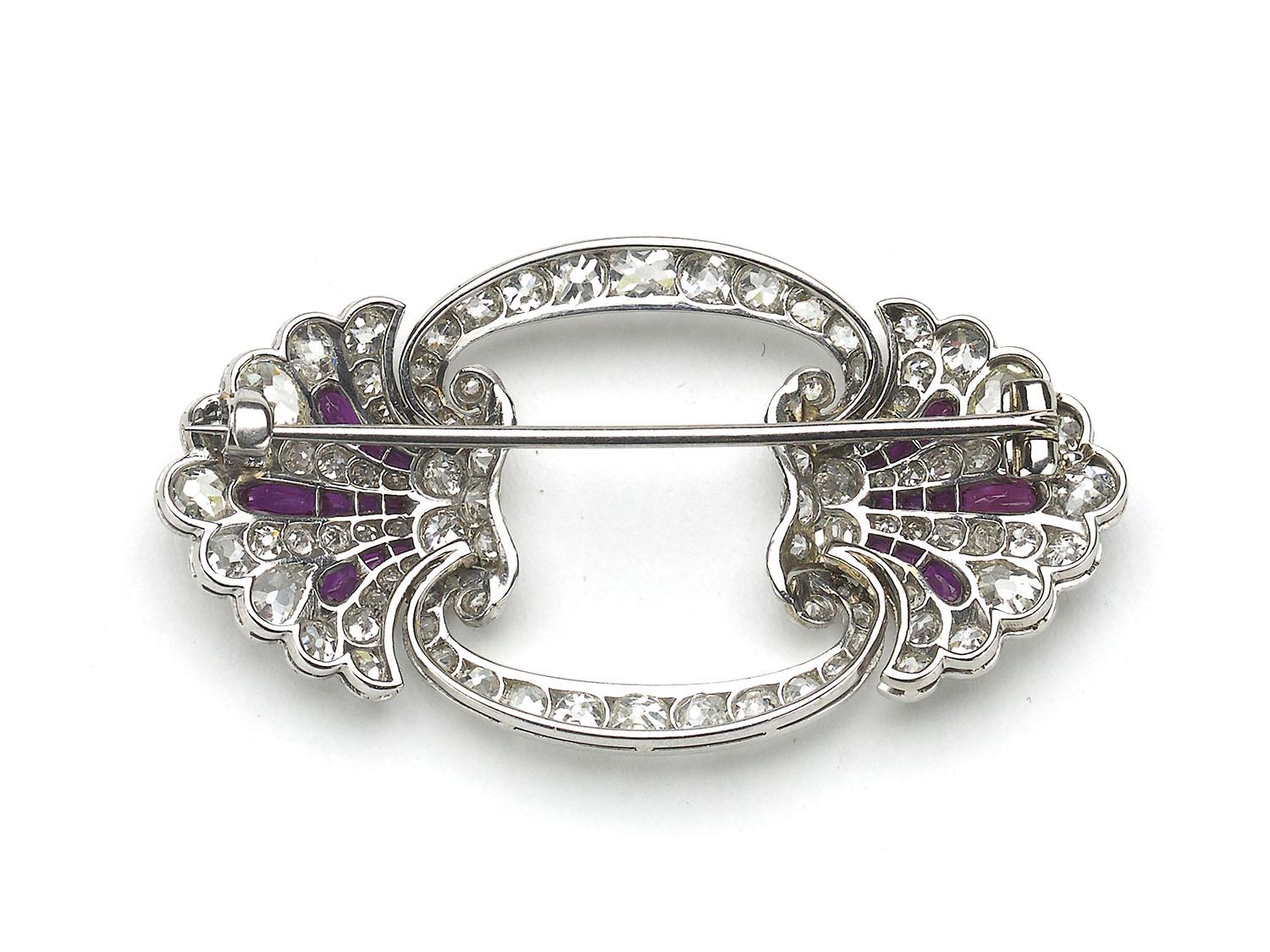 An Art Deco ruby and diamond brooch set with old-cut diamonds, with calibré-cut ruby sprays, mounted in platinum, circa 1935. With an estimated total diamond weight of 3.20ct.