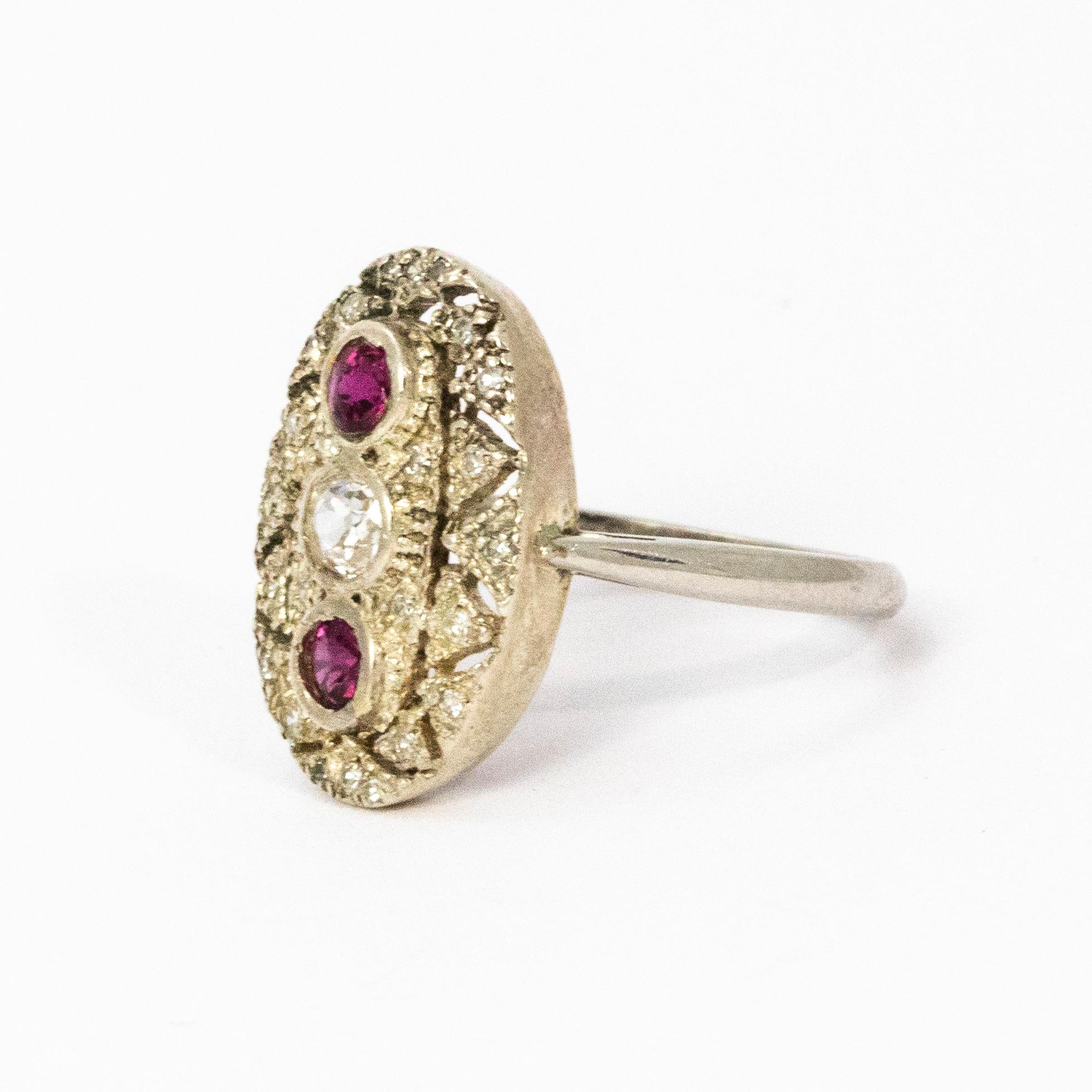 Stunning Art Deco period panel ring set with a central diamond and pink rubies above and below. This ring is is made up of open worked platinum.

Ring size: J or 4 3/4