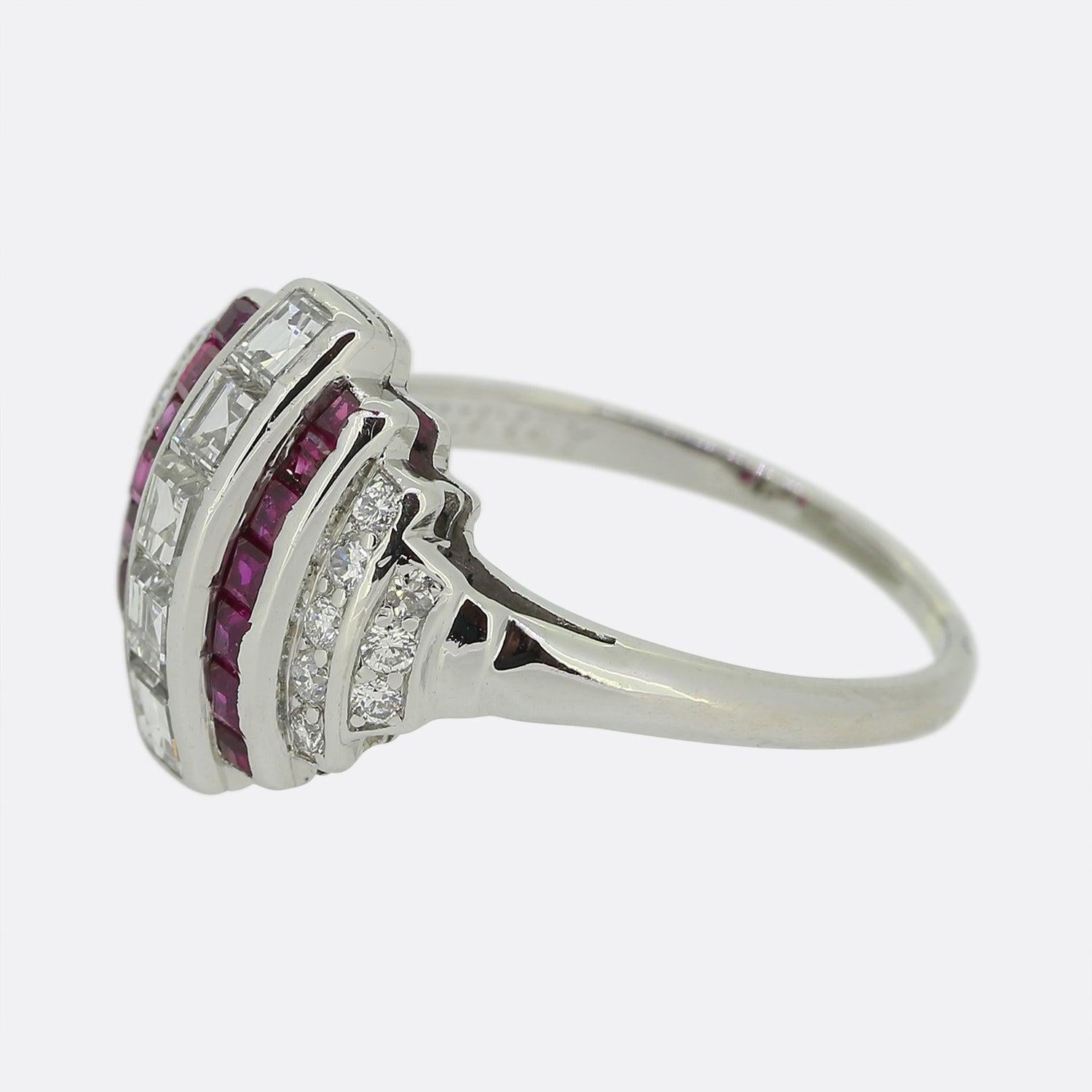 This is a truly wonderful Art Deco ruby and diamond ring. The ring features a central layer of five carre cut diamonds and then a layer of square cut rubies and then two further layers of old European cut diamonds. The style is a perfect example of
