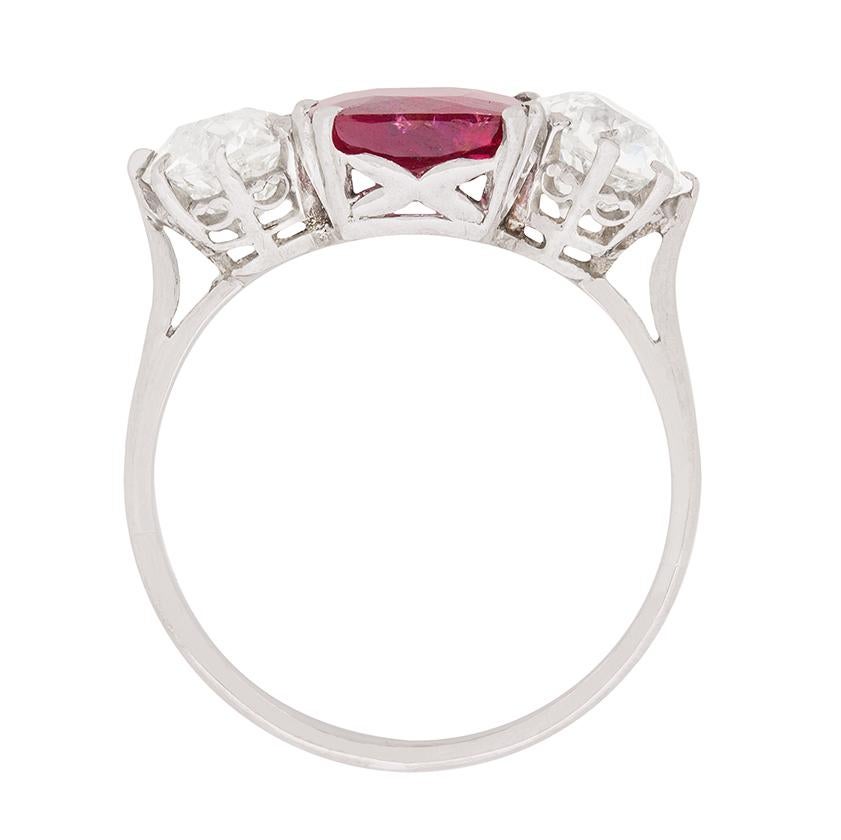 This stunning ring highlights a natural, non-heat treated and Madagascan ruby in the centre. It has been certified by GCS, an independent certification company in London. The emerald cut ruby has been claw set using a double pring setting, whilst