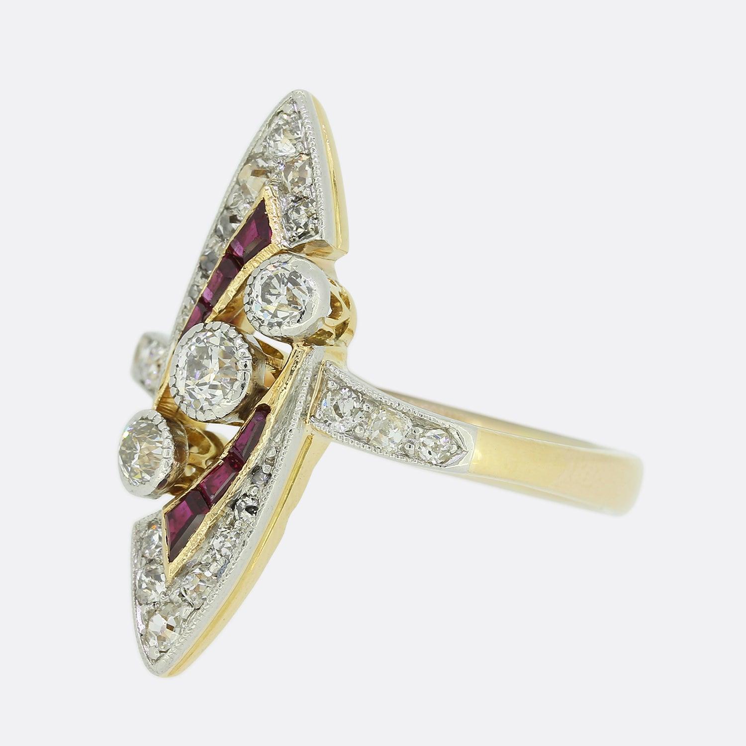 This is an impressive Art Deco ruby and diamond navette ring. At the centre of an open marquise-like shaped design we find three milgrain set old cut diamonds in a diagonal line formation. This fine detailed setting is continued around the entirety