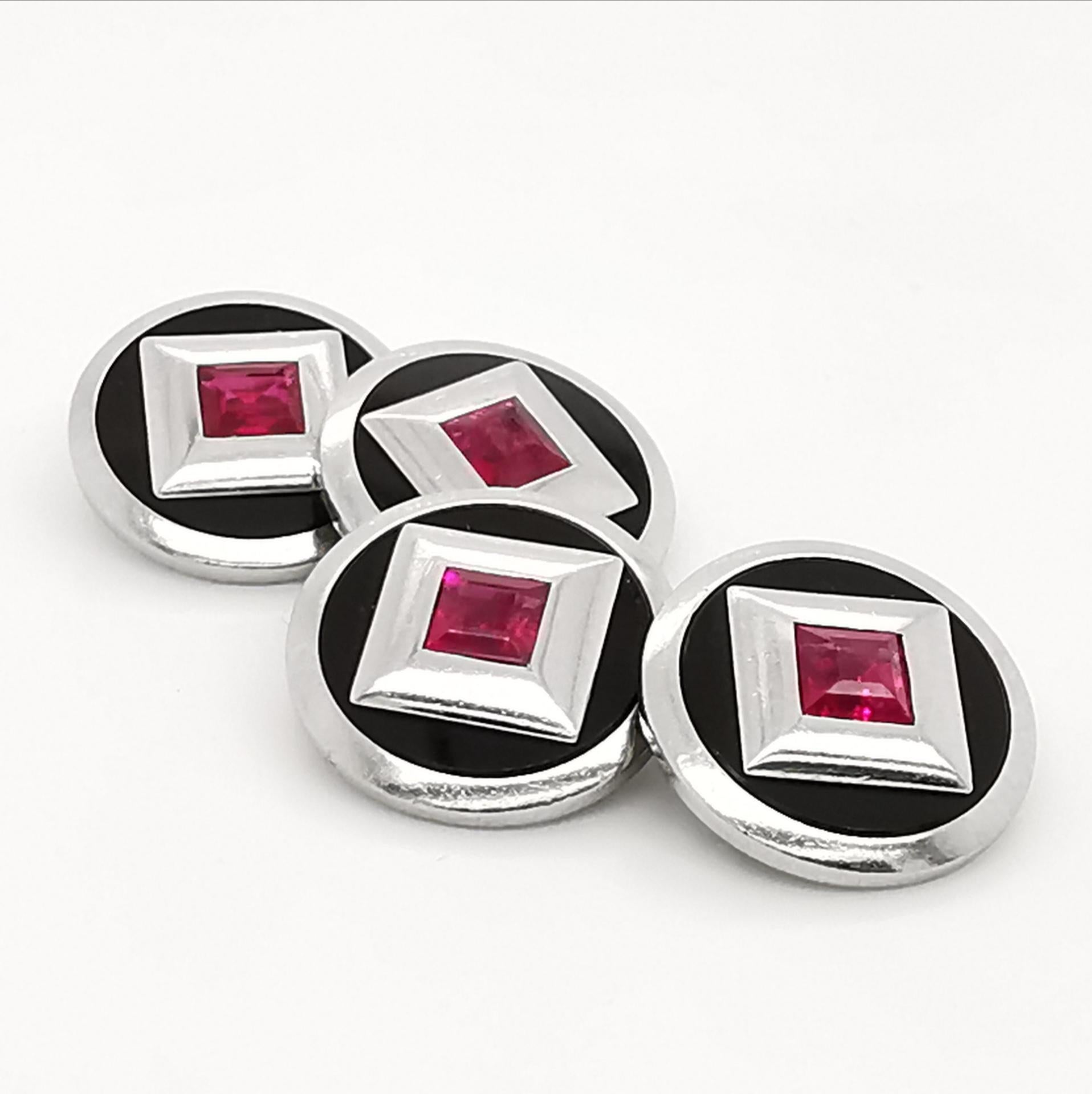 A pair of French, Art Deco, black onyx and ruby cufflinks, mounted in platinum, with square-cut rubies, in heavy, platinum, square settings, within discs of black onyx, in platinum surrounds, with French dog marks for platinum and numbered 25, with