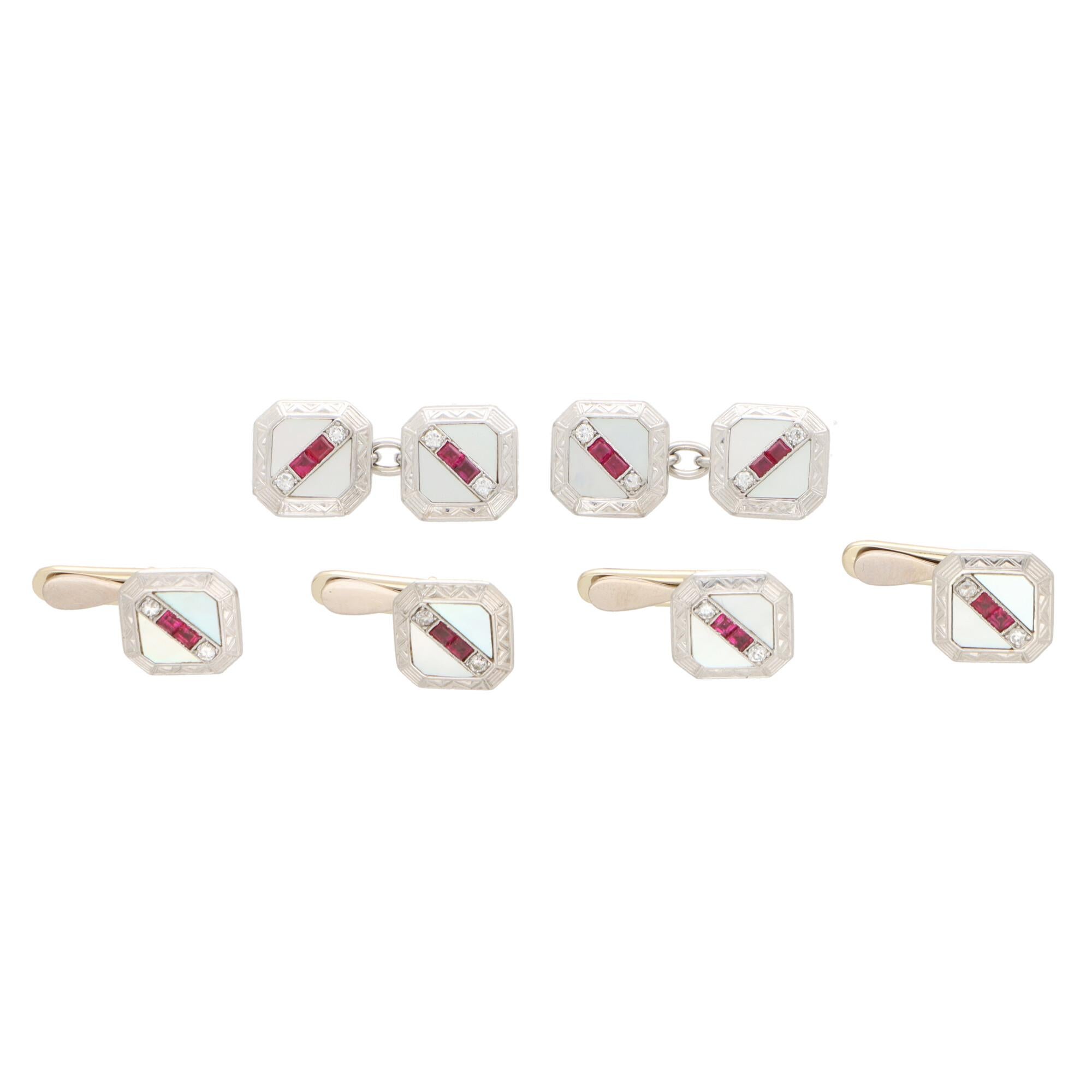 A beautiful Art Deco cufflink and shirt stud dress set, set with diamonds, rubies and mother of pearl.  

The set is comprised of four beautifully crafted shirt studs and a pair of perfectly matched double-sided chain-link cufflinks.

Each square