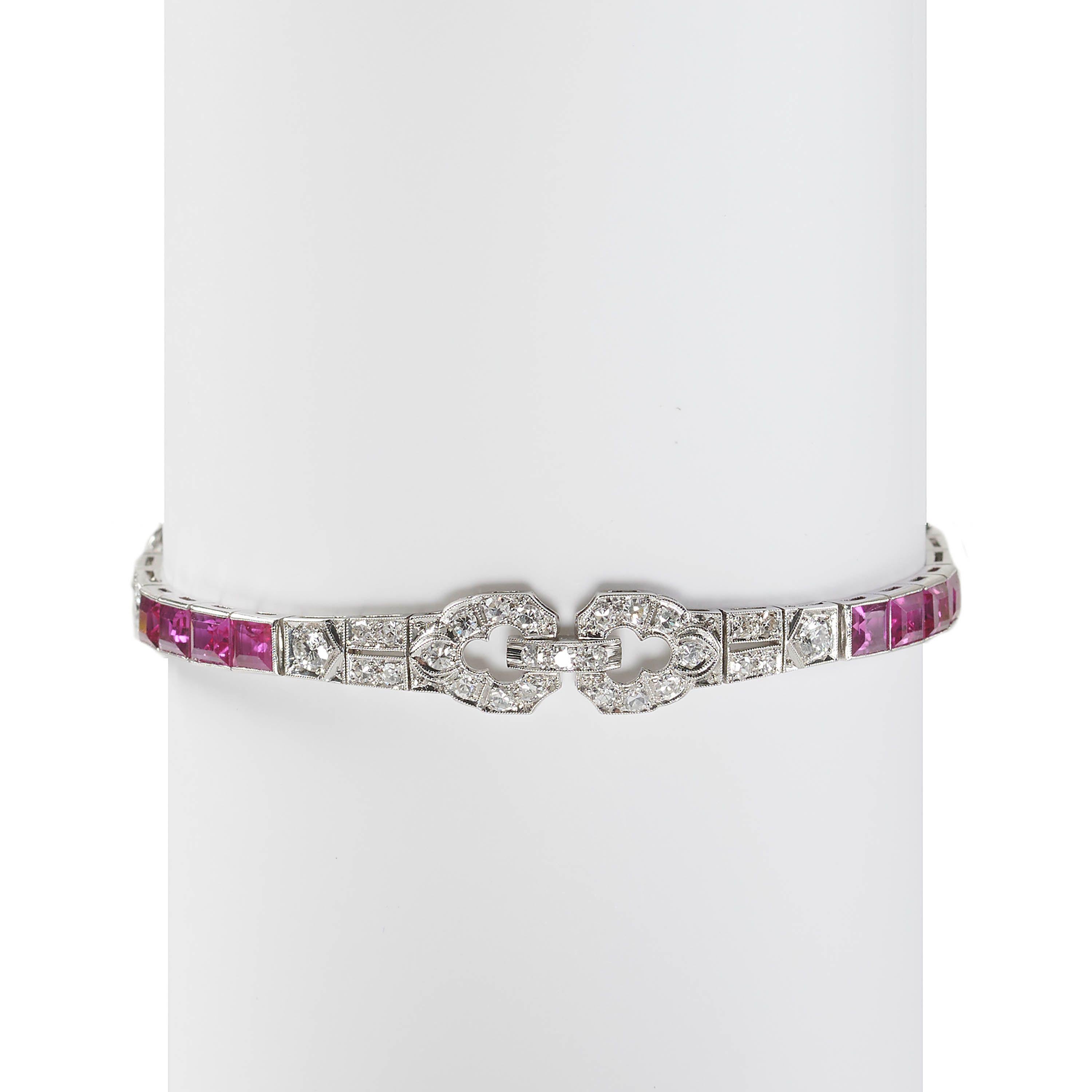 An Art Deco ruby, diamond and platinum bracelet, featuring a repeating pattern of three sets of four baguette-cut rubies, in channel settings and three sets of geometric motifs, set with eight-cut and round brilliant-cut diamonds, in grain settings,