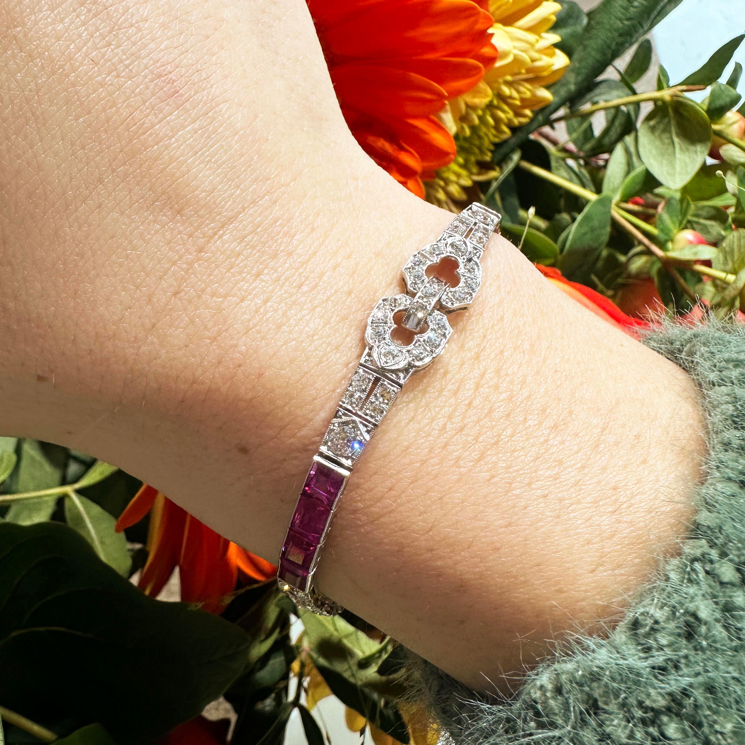 An Art Deco ruby, diamond and platinum bracelet, featuring a repeating pattern of three sets of four baguette-cut rubies, in channel settings and three sets of geometric motifs, set with eight-cut and round brilliant-cut diamonds, in grain settings,