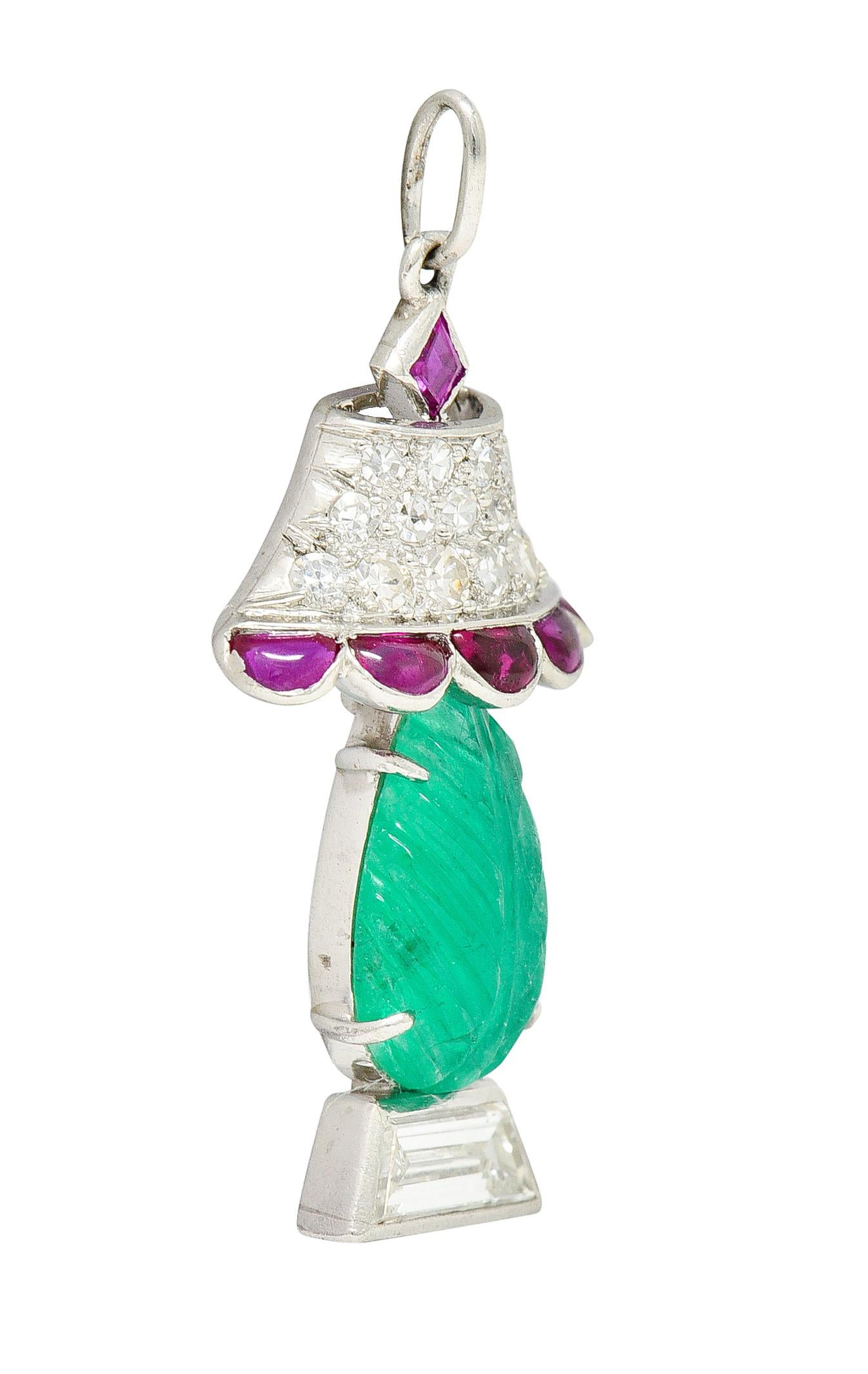 Charm is designed as a lamp with a Mughal carved emerald as body. Translucent bluish green and carved to depict foliate while weighing approximately 1.00 carat. Lampshade is pavè set with single cut diamonds while base is a trapezoid cut diamond.