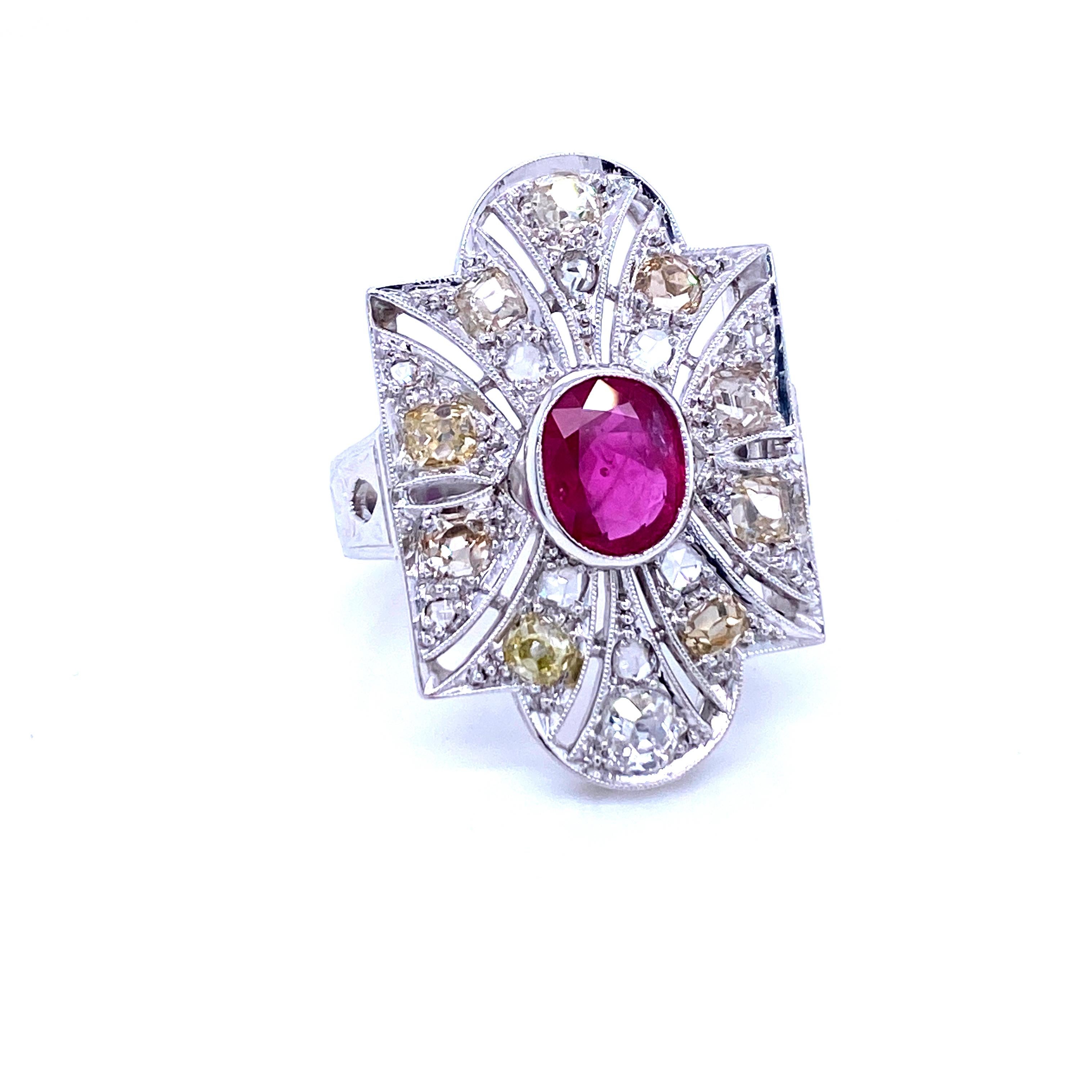 Authentic and unusual Art Deco ring centered with a prominent 1.32 carat Natural Ruby and surrounded by Old mine cut diamonds, weighing all together 3 carats, graded from M to S color and VS clarity.
Entirely hand crafted in Platinum and 18k Gold,