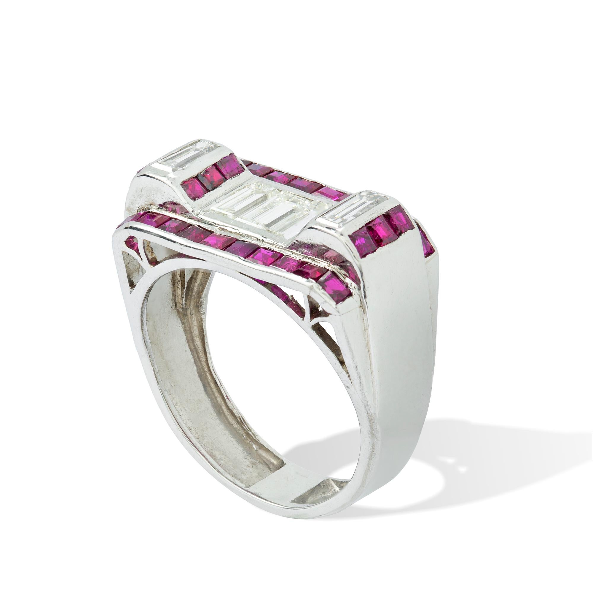 Sortija Art Decó de rubí y diamantes, engastada con tres diamantes talla baguette, un diamante talla baguette separando dos filas de tres rubíes talla calibre engastados en monturas semicirculares elevadas a cada lado, una línea de rubíes talla