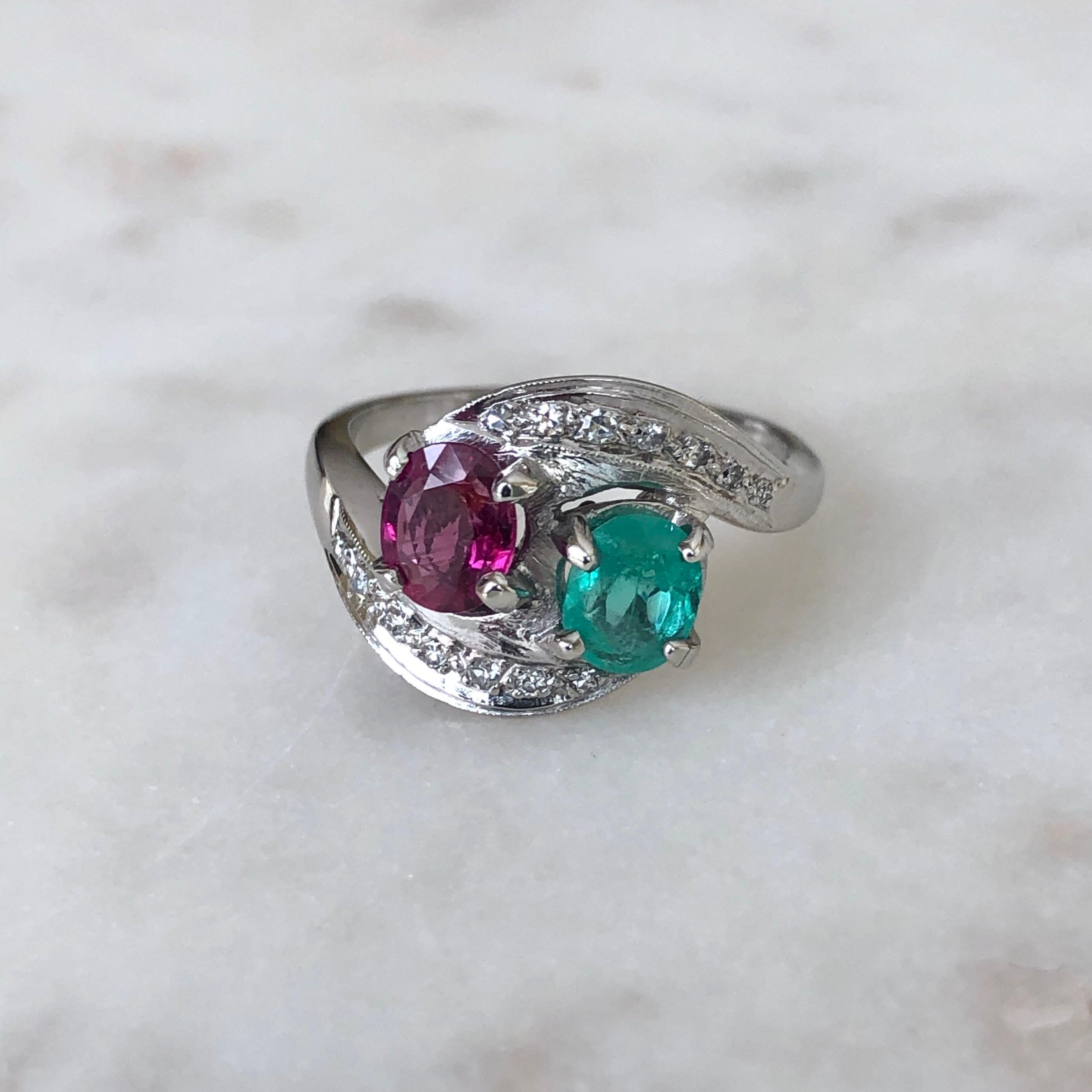 An Exclusive Antique Art Deco Toi et Moi Emerald Ruby Diamond Platinum Engagement Ring 
Primary Stone: 100% Natural Ruby, Emerald and Diamond 
Shape or Cut: Oval Cut
Total Gemstone Weight: Approx. 1.73 Carat 
Average Color Gemstone: Best Color