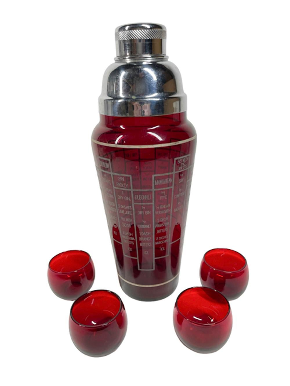 Art Deco ruby glass cocktail shaker with 16 cocktail recipes in white graphics on the tapered shaker, the 2 part domed chrome lid is fitted with an integral strainer. Together with four roly poly cocktail glasses.