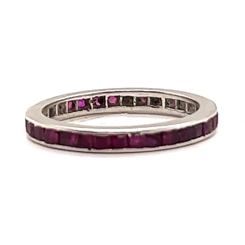 One Art Deco Ruby Platinum Eternity Band Ring. Featuring 30 square cut rubies with a total weight of approximately 1.50 carats. Crafted in platinum. Circa 1920s. The ring is a size 4 1/2. 

About this Item: This Art Deco Eternity band is perfect for