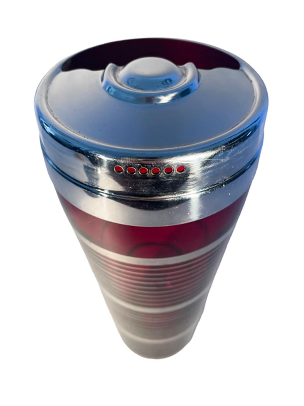 Art Deco cocktail shaker in ruby red glass with a polished foot and platinum bands and chrome lid. The two-part lid allows the shaker to also be used as a mixing glass for cocktails that should be stirred. The inner lid has a large opening which