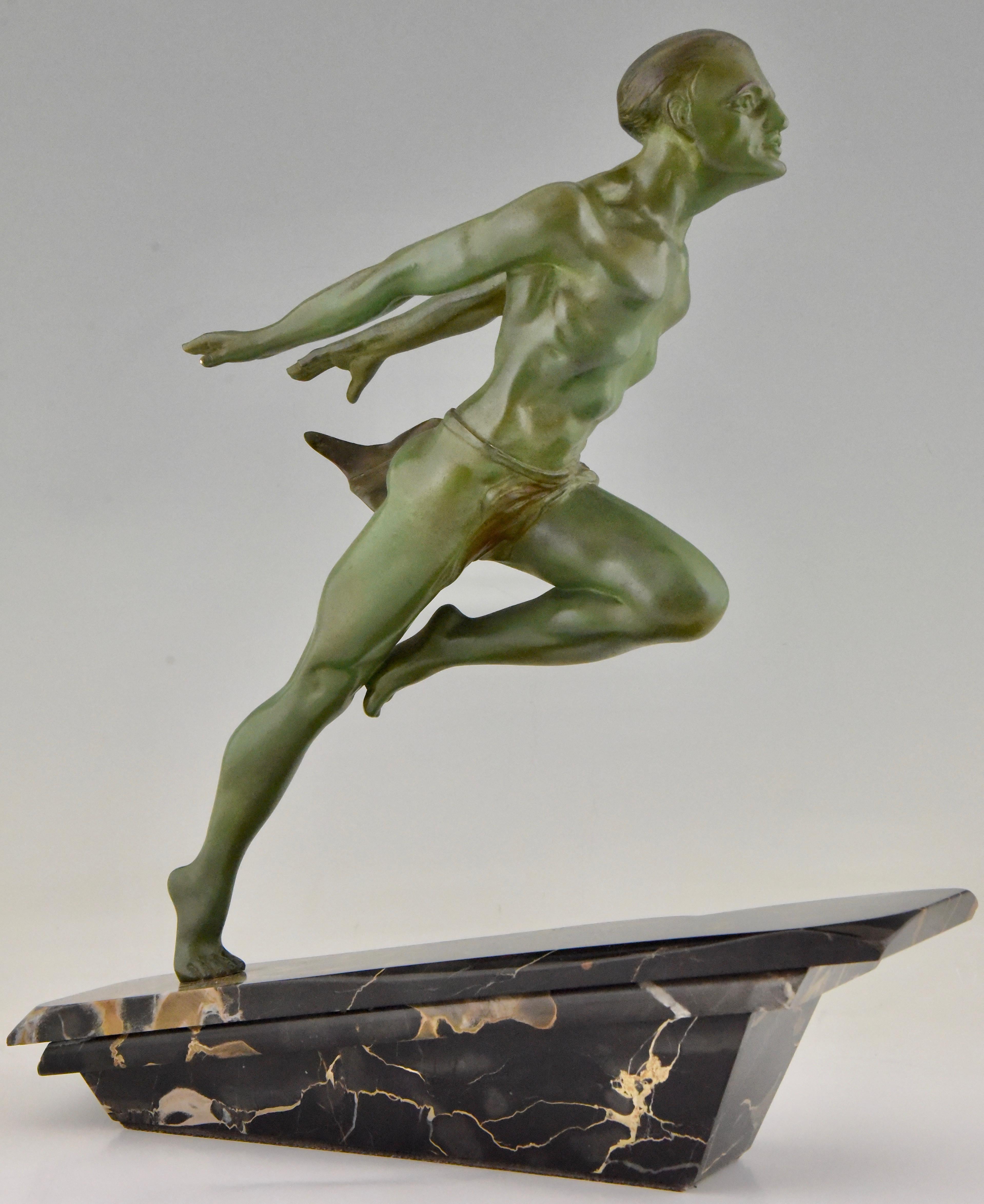 Art Deco running man statue by L Valderi French, circa 1930. Verdigris patina metal sculpture on sculpted portoro angled marble base. The movement of the man, reminiscent of the great male statue known by Jean de Roncourt. This one is signed L.