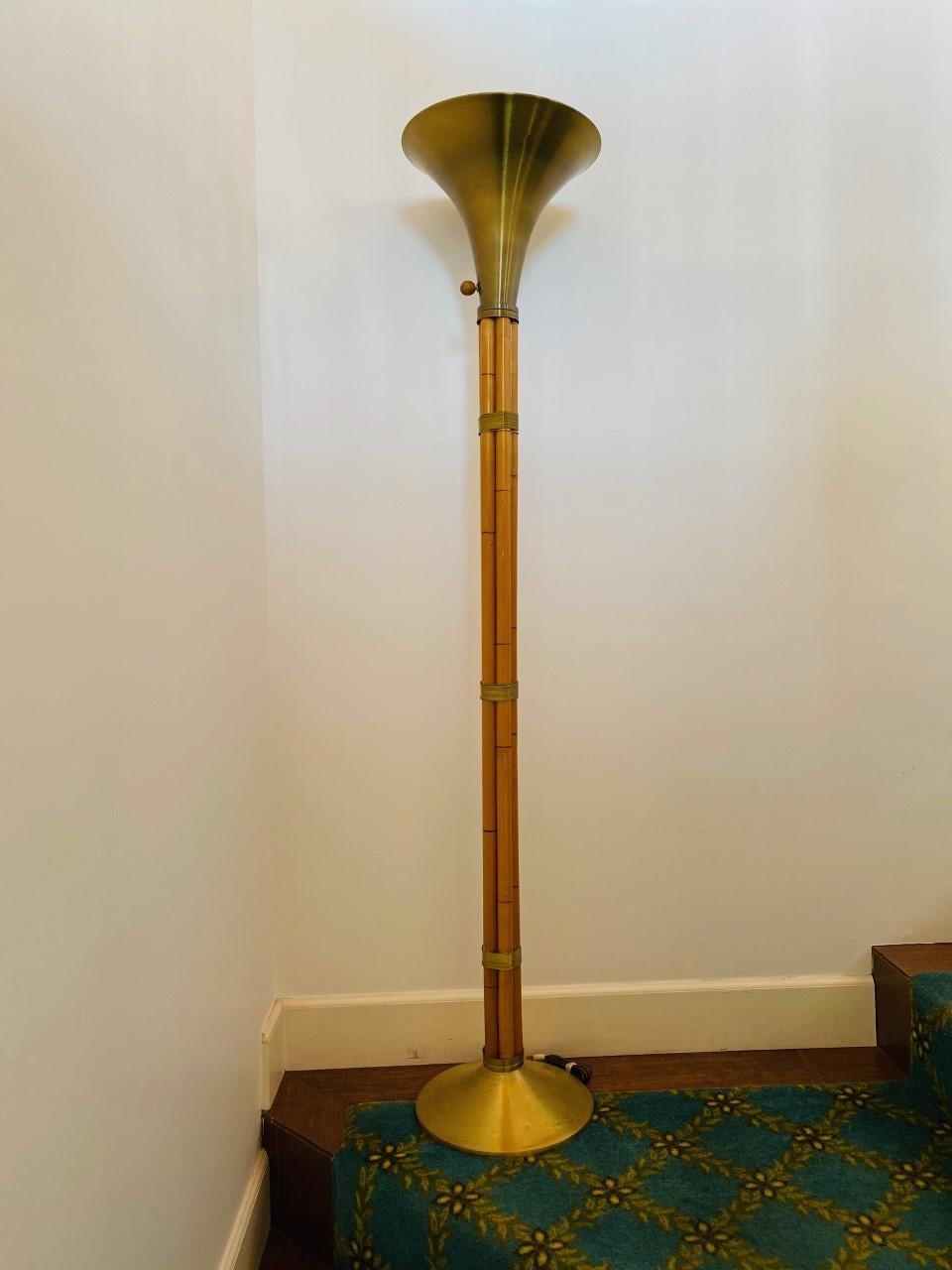 1930s brass and faux-bamboo Russel Wright for Raymor torchère floor lamp. Five maple rods faux finished to look like bamboo are wrapped with solid brass wire. The bases and tops are solid spun brass. Original wooden ball knobs on 3-way switches.