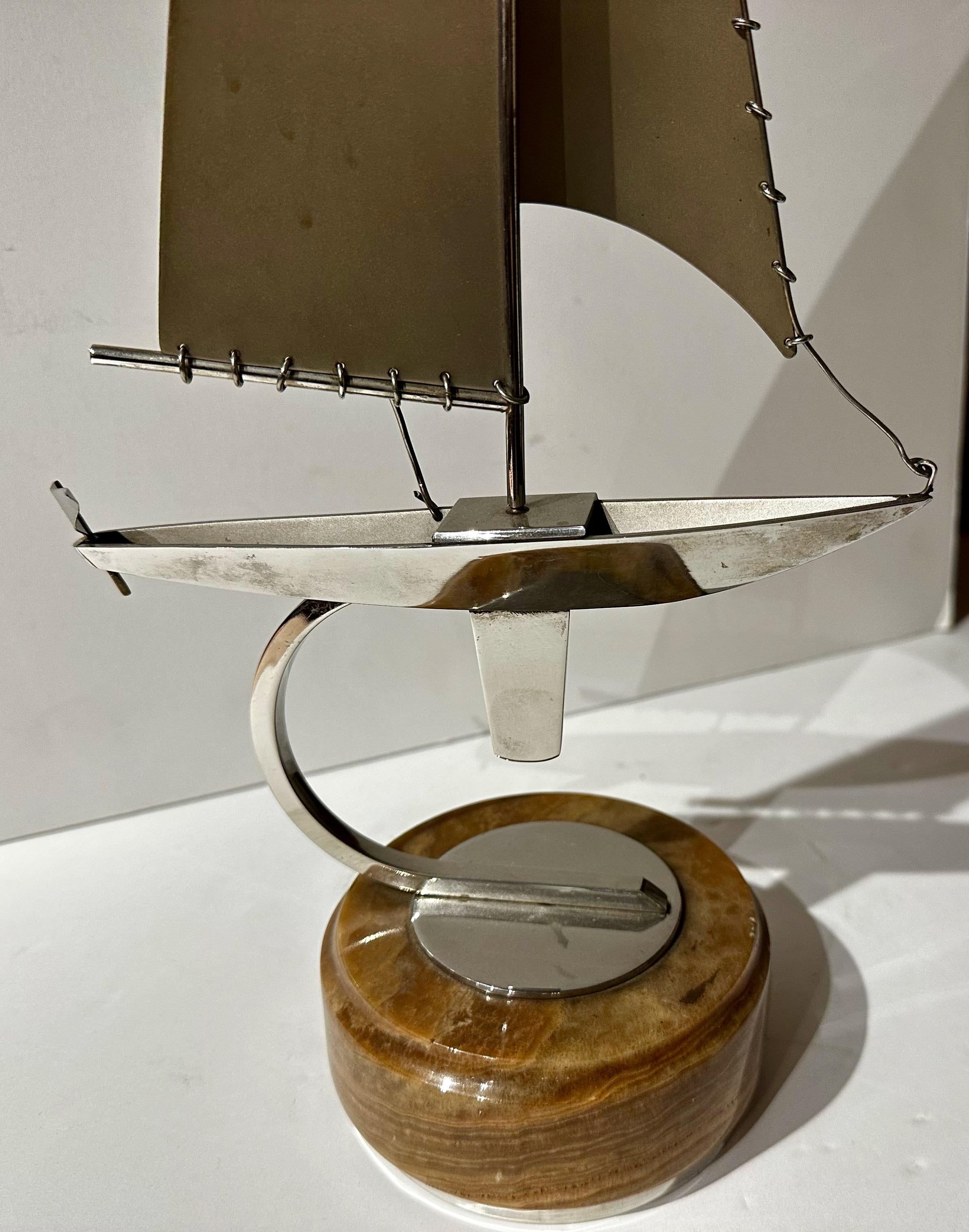 Art Deco Sailboat Model mixed metals and wood. Excellent construction and outstanding model design. The finish is near perfect. The metal sails are all detailed with round rings for support and style. This high-quality ship is simple but elegant as