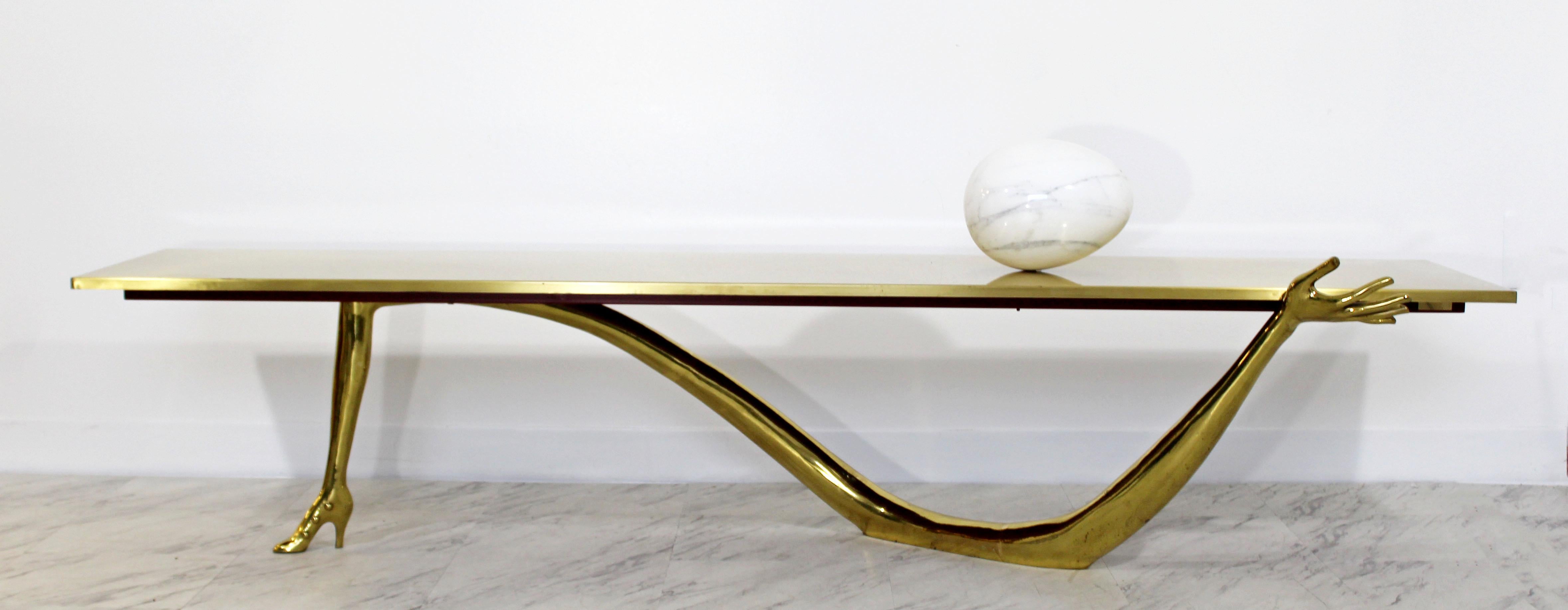 For your consideration is an original Leda, brushed brass varnished, Surrealist, low coffee table, with a Carrara marble egg, designed by Salvador Dali, circa 1935, made in Spain circa the 1990s and numbered 40. In good condition with wear